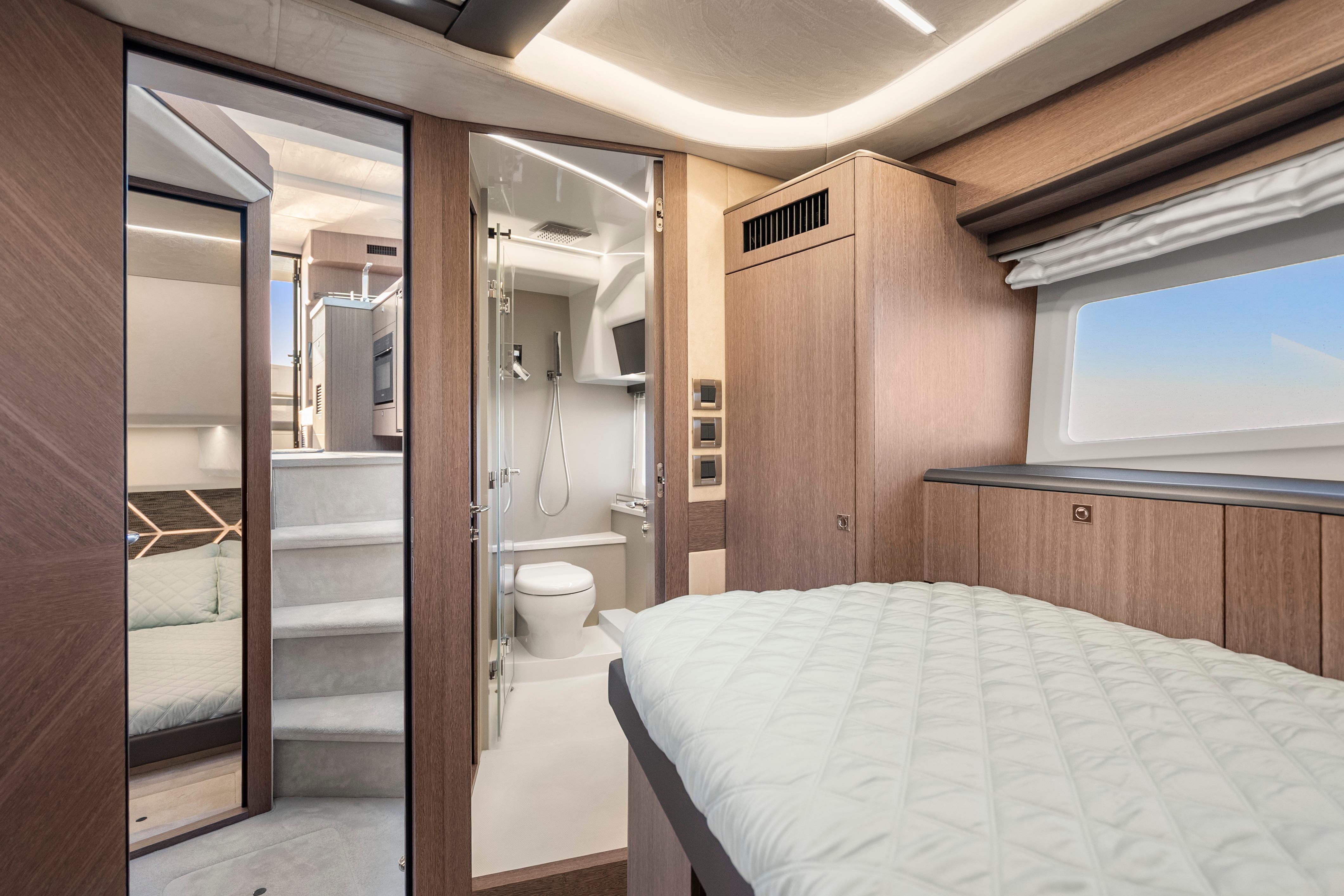 Luxurious interior of 2023 Galeon 400 Fly yacht featuring bedroom and modern bathroom.