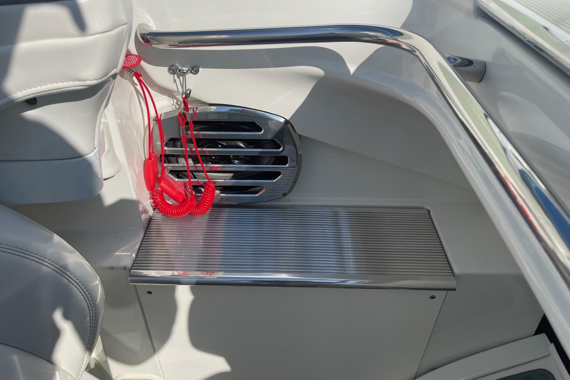 Interior of a 2004 Formula 382 FASTech boat, featuring sleek metal accents and red safety lanyard.