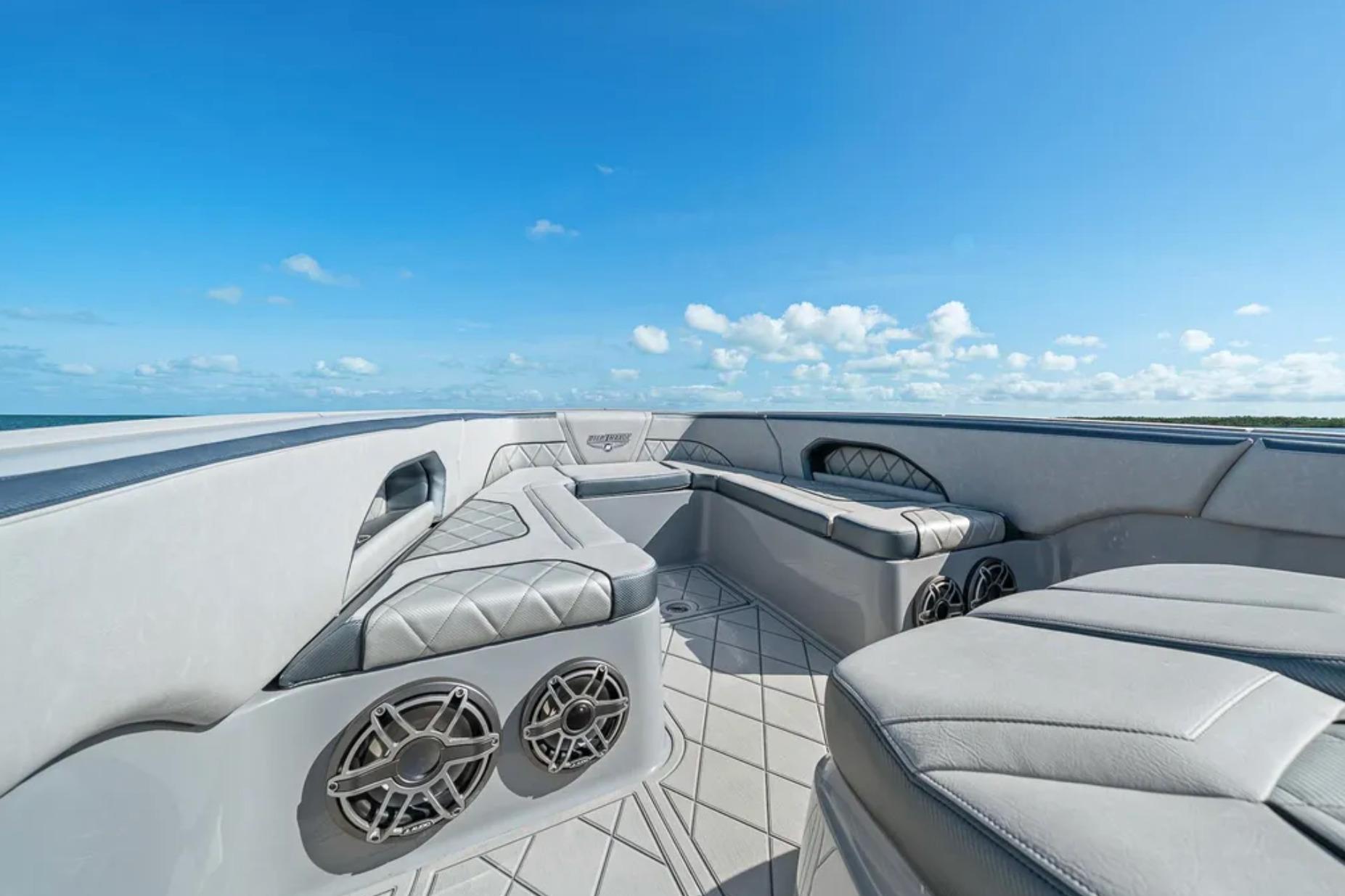 Luxurious seating on 2025 Deep Impact 369 Sport boat under clear blue sky.