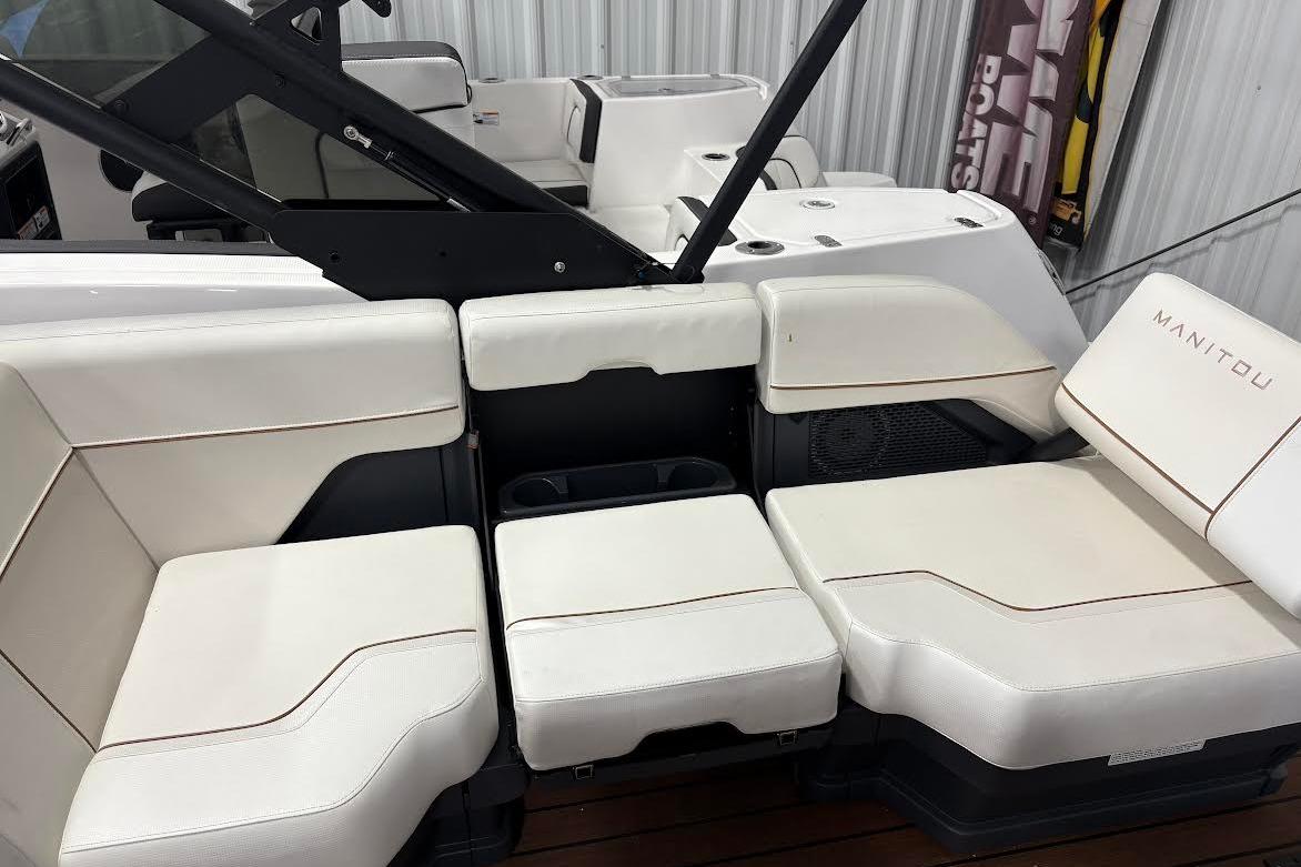 2023 Manitou EXPLORE 26 SHP 575 boat interior with white cushioned seating.