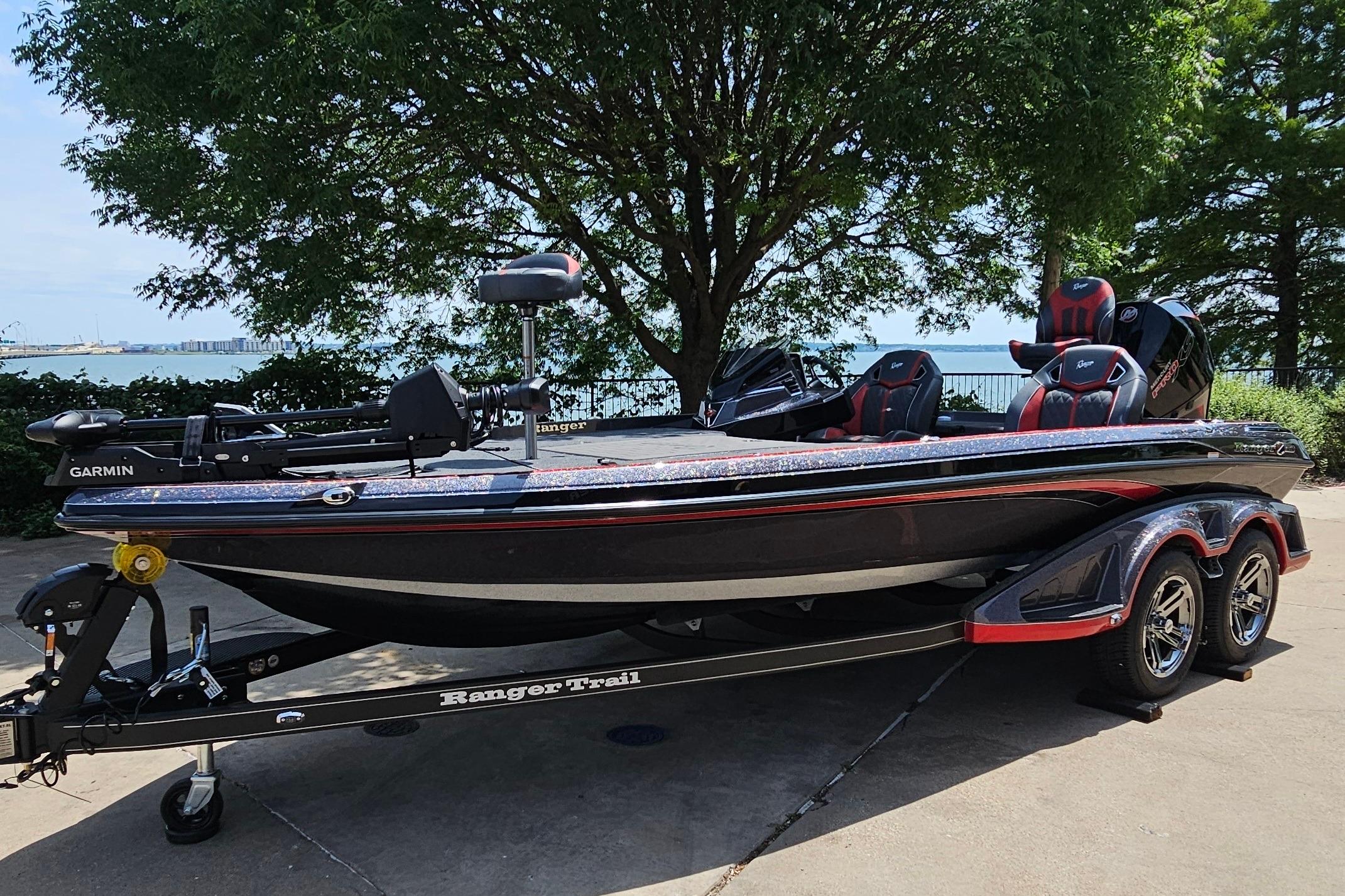 2026 Ranger Z520R boat on trailer, parked near a lake with trees in the background.