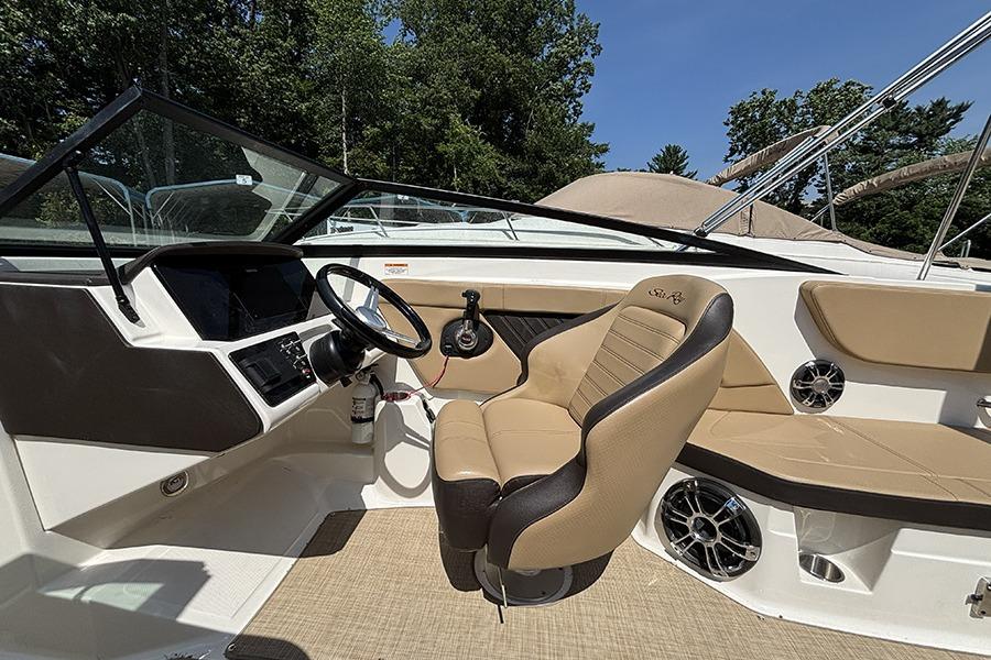 2019 Sea Ray SPX 230 Outboard boat interior with steering wheel and seating.