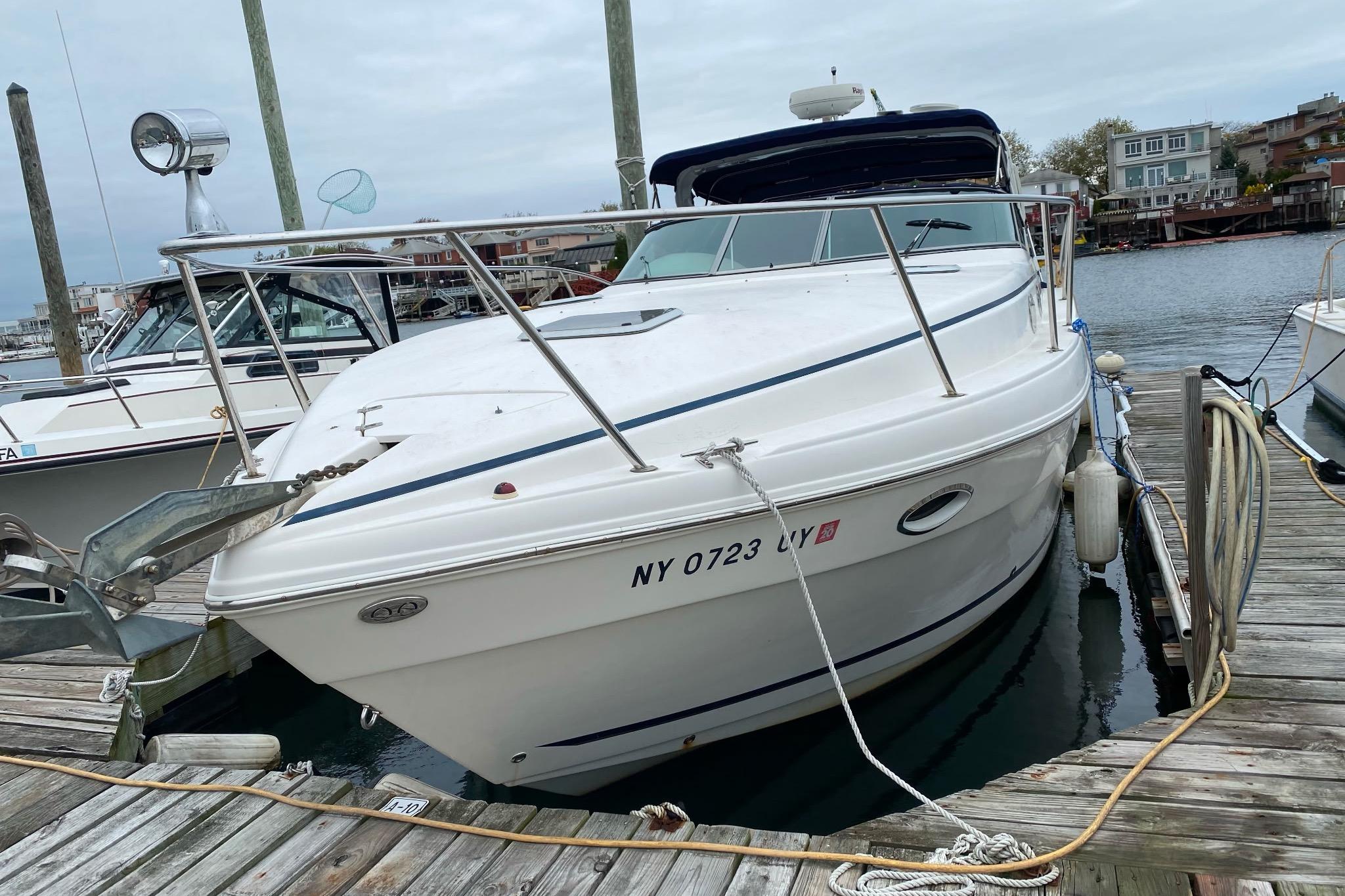 2003 Rinker Fiesta Vee 342 boat docked at marina, front view.