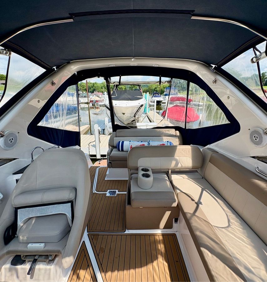Interior of a 2014 Regal 30 Express with beige leather seating and wood flooring.