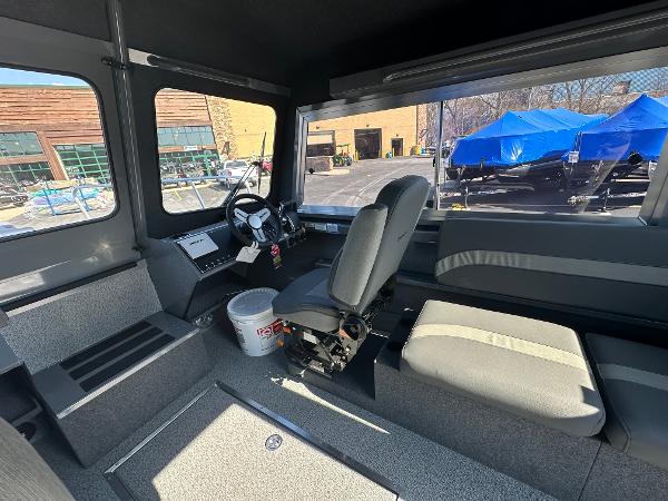 Interior of 2024 Spartan 260 Maximus Pro XL boat with seating and steering console.
