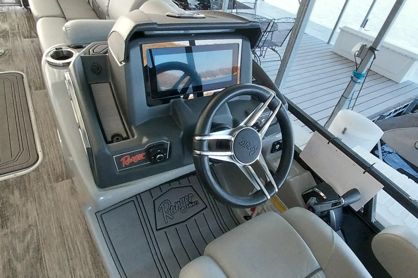 2023 Ranger 2500LS boat dashboard with steering wheel and touchscreen display.