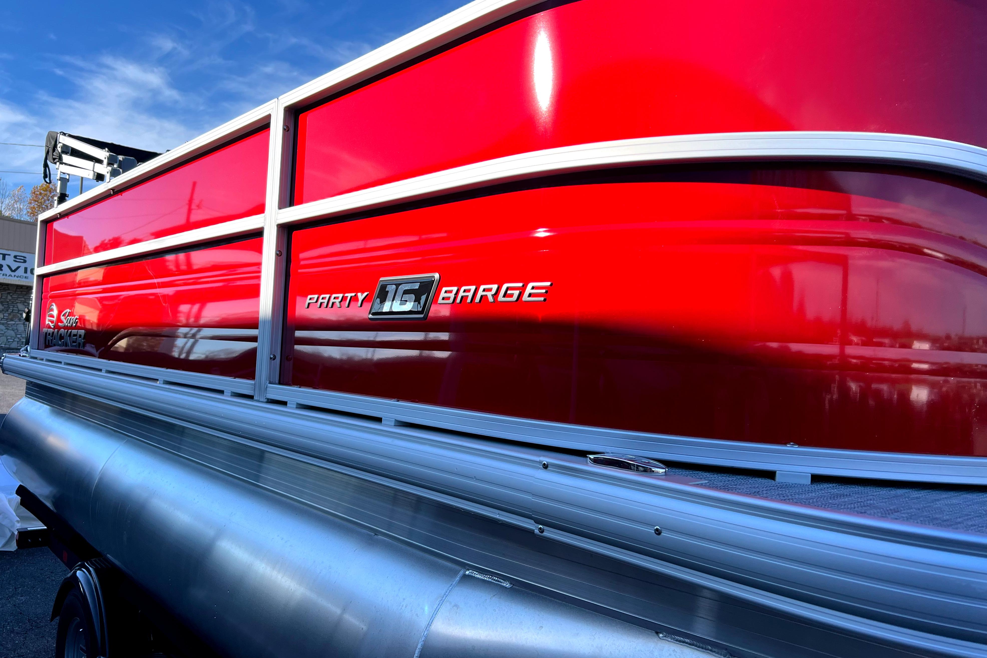2026 Sun Tracker Party Barge 16 DLX pontoon boat with vibrant red exterior.