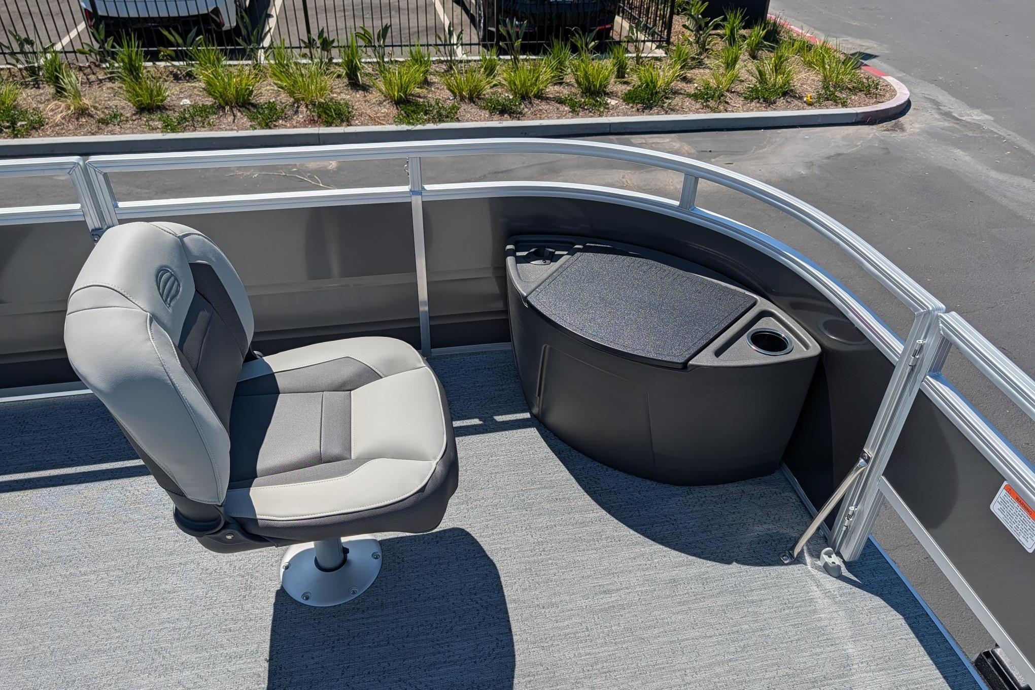 2026 Sun Tracker Fishin' Barge 22 DLX interior with seating and storage.