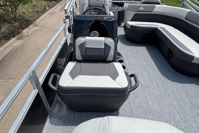 2026 Sun Tracker Bass Buggy 18 DLX pontoon boat interior with gray seating and carpeted floor.