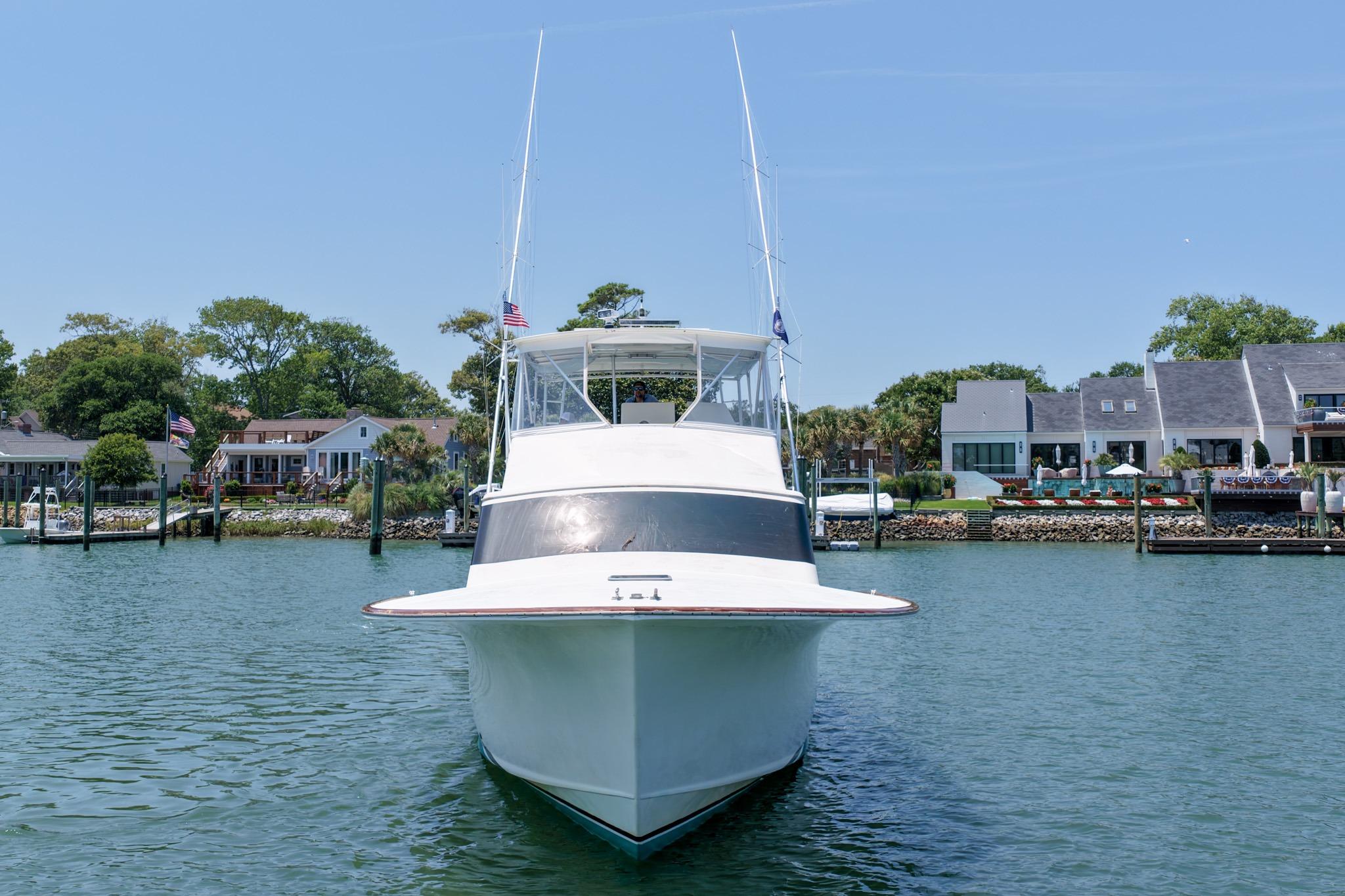 1998 Blackwell Custom Carolina Sportfish boat docked in a scenic waterfront area.