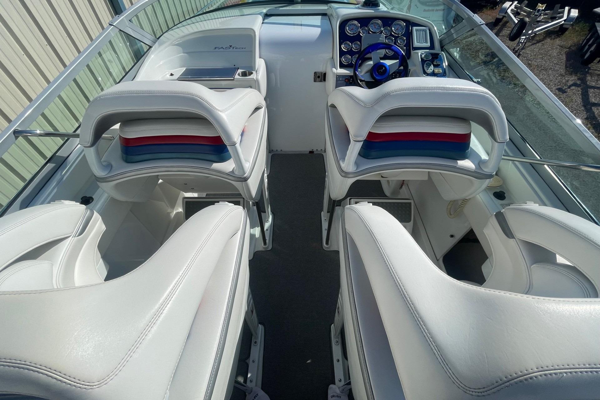 2004 Formula 382 FASTech boat interior with white seating and control panel.