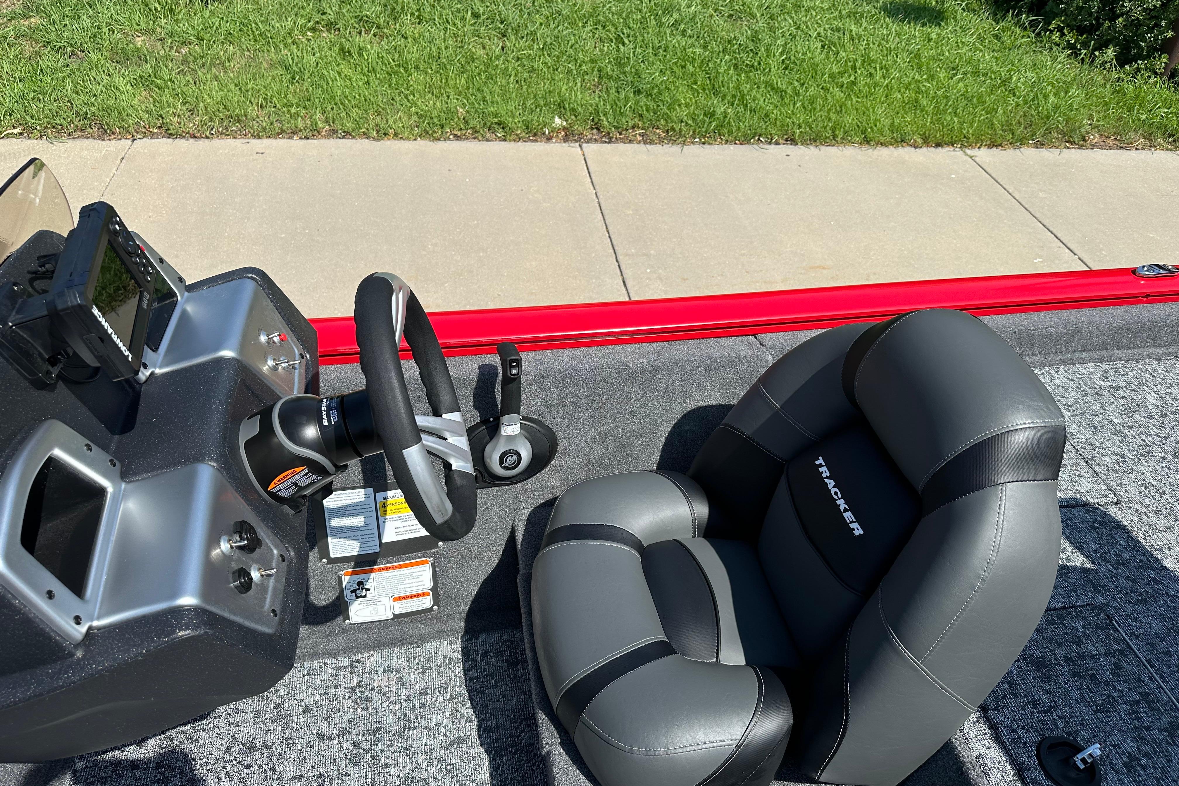 2026 Tracker Pro Team 195 boat interior with steering wheel and seat, featuring modern design.