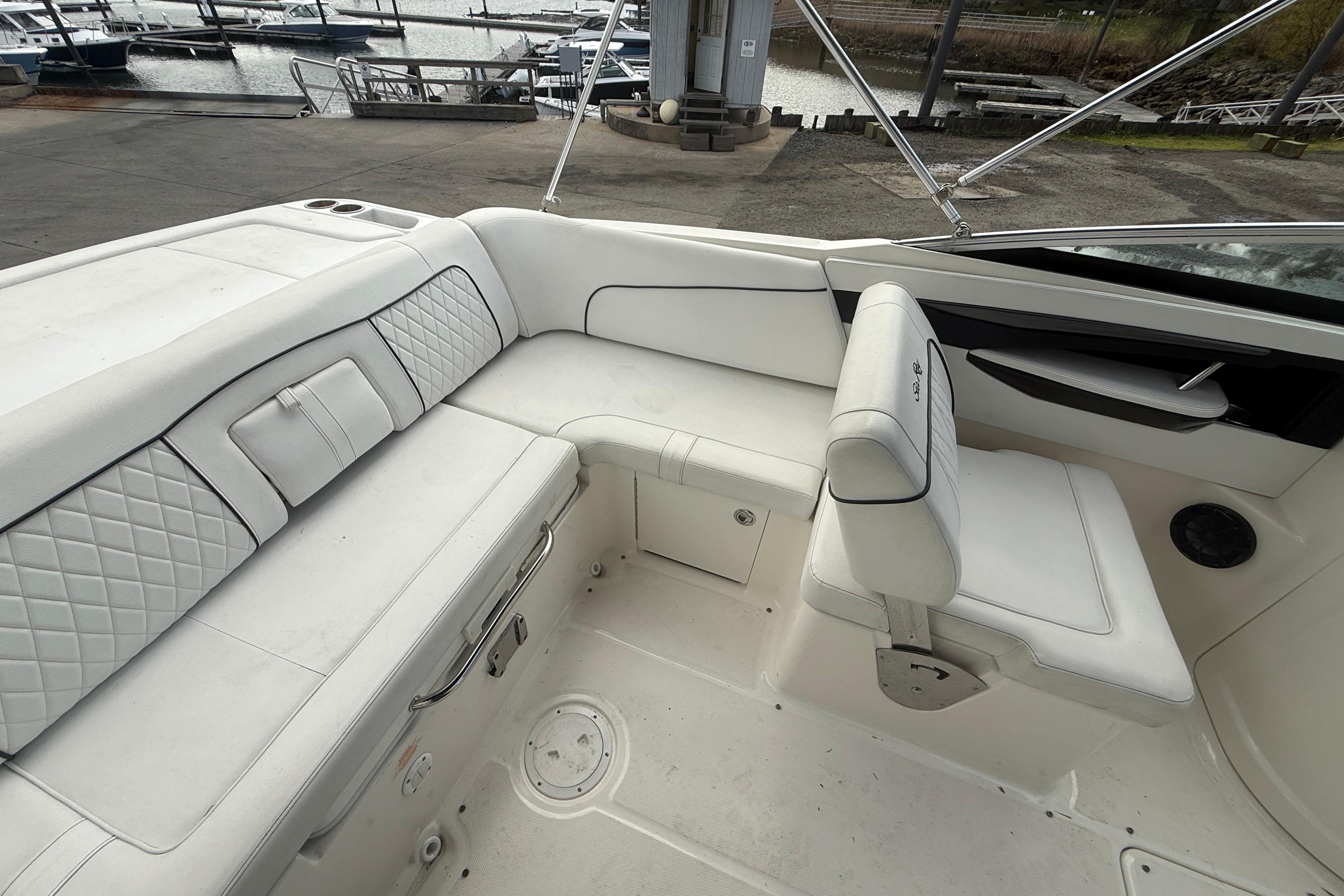 2015 Sea Ray 240 Sundeck interior with white seating, docked at marina.