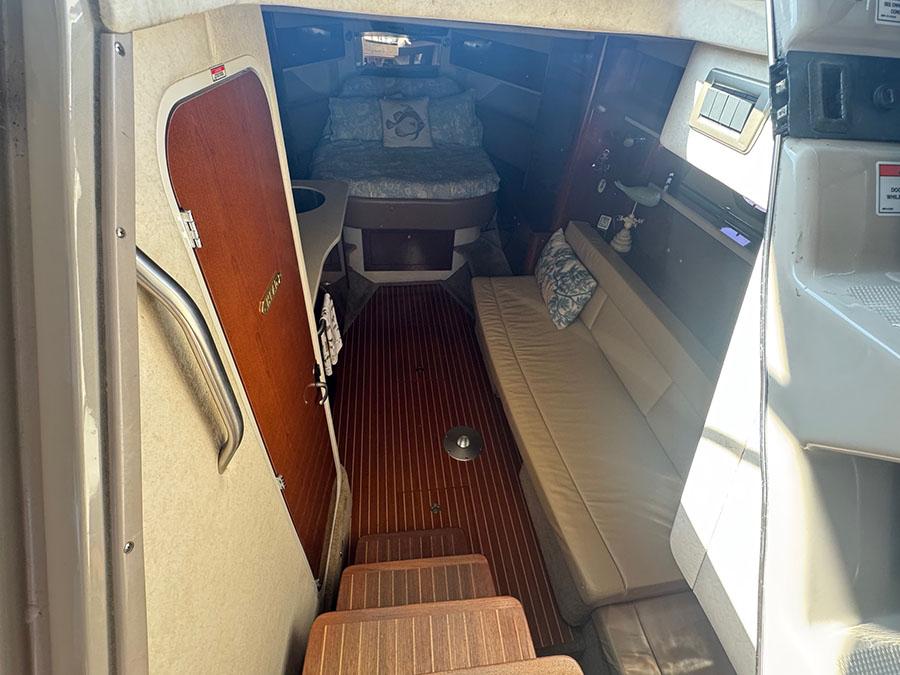 Interior of 2009 Sea Ray 330 Sundancer, featuring cozy seating and wooden flooring.