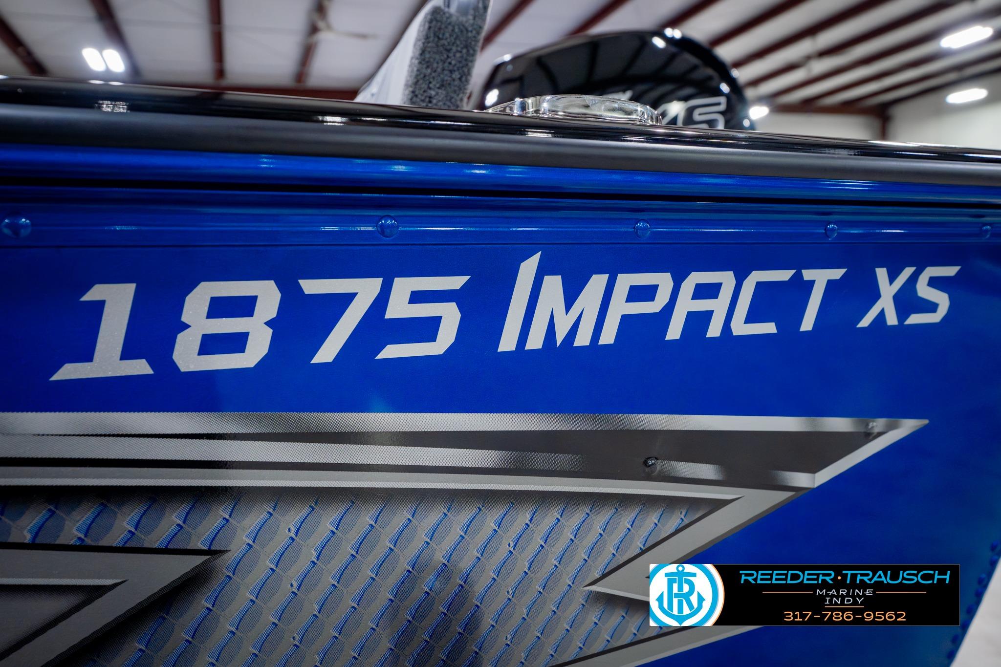 2026 Lund 1875 Impact XS boat, blue exterior with bold lettering, displayed indoors.