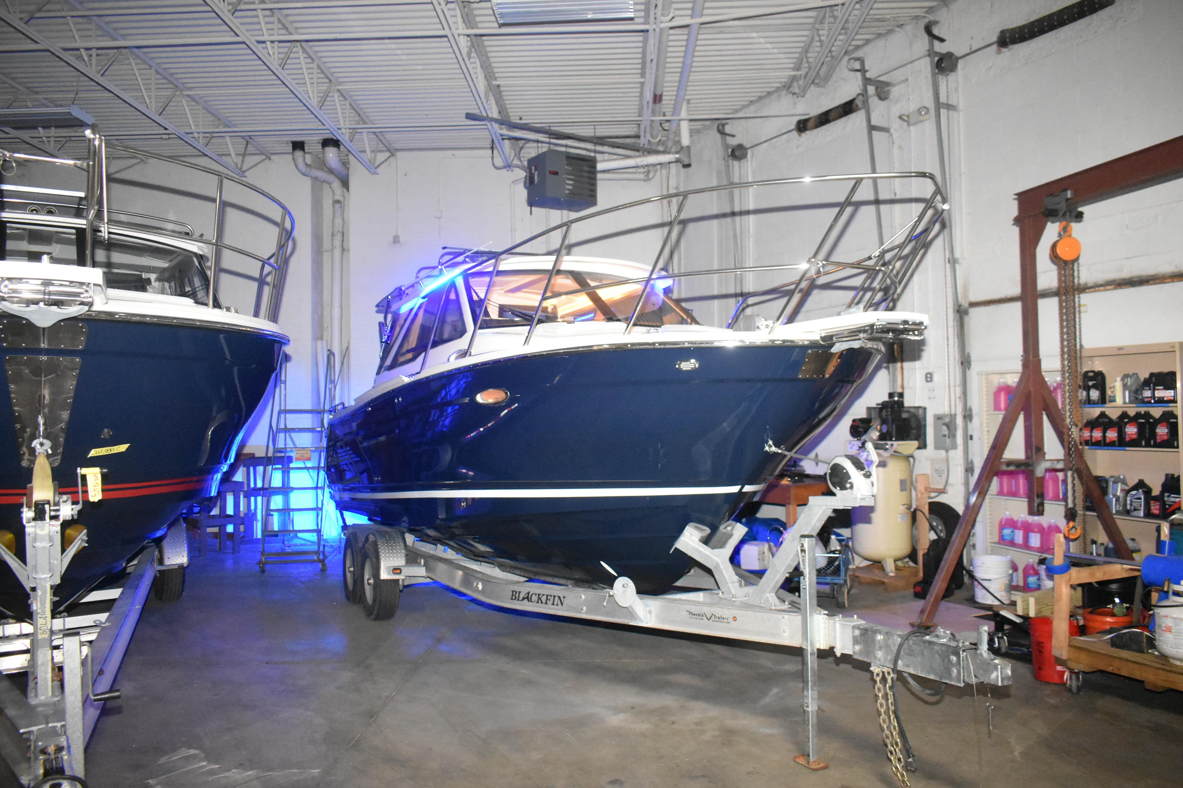 2026 Cutwater C-248 Coupe boat on trailer in indoor storage facility.