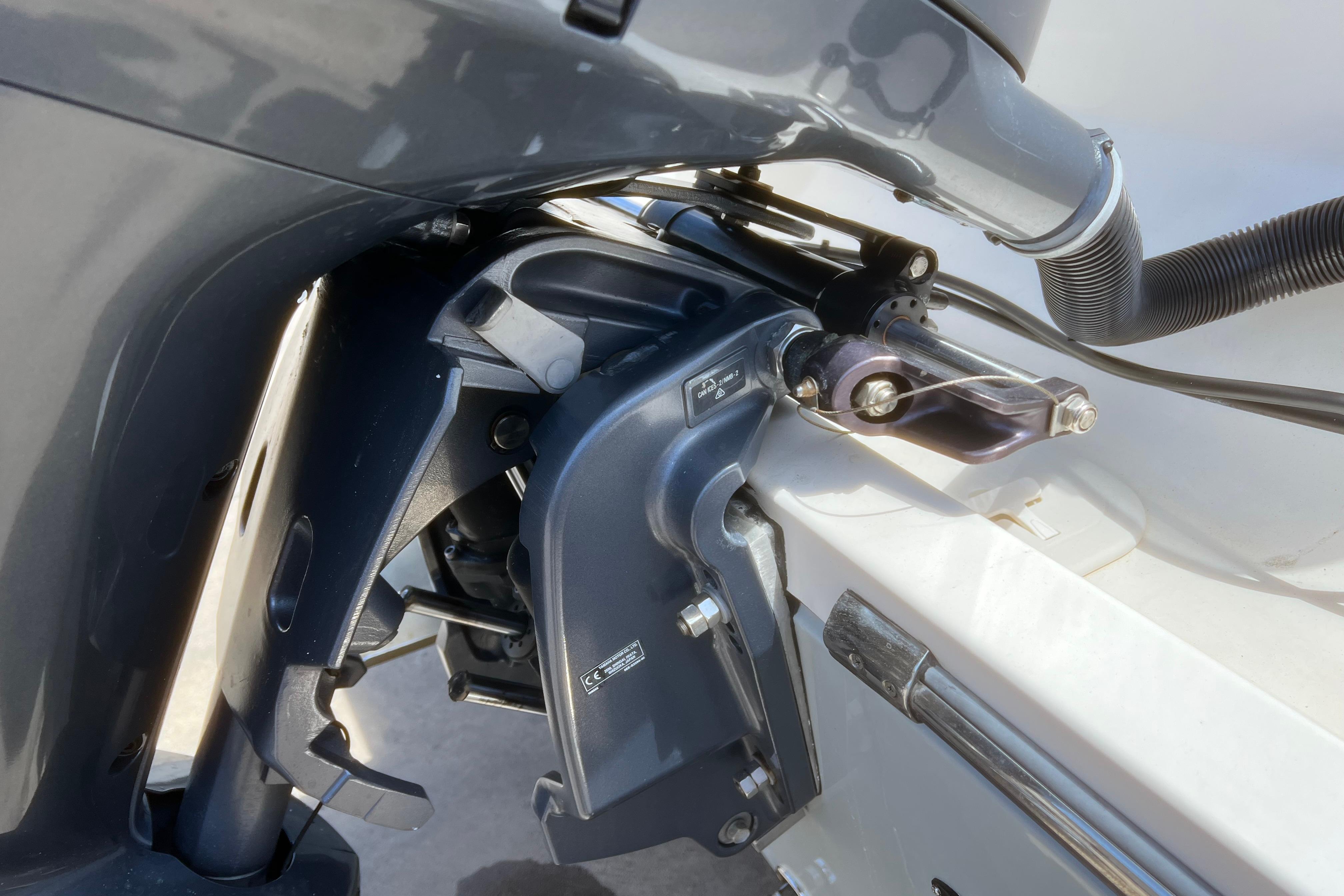 Close-up of a 2018 Cobia 201 Center Console boat engine detail.