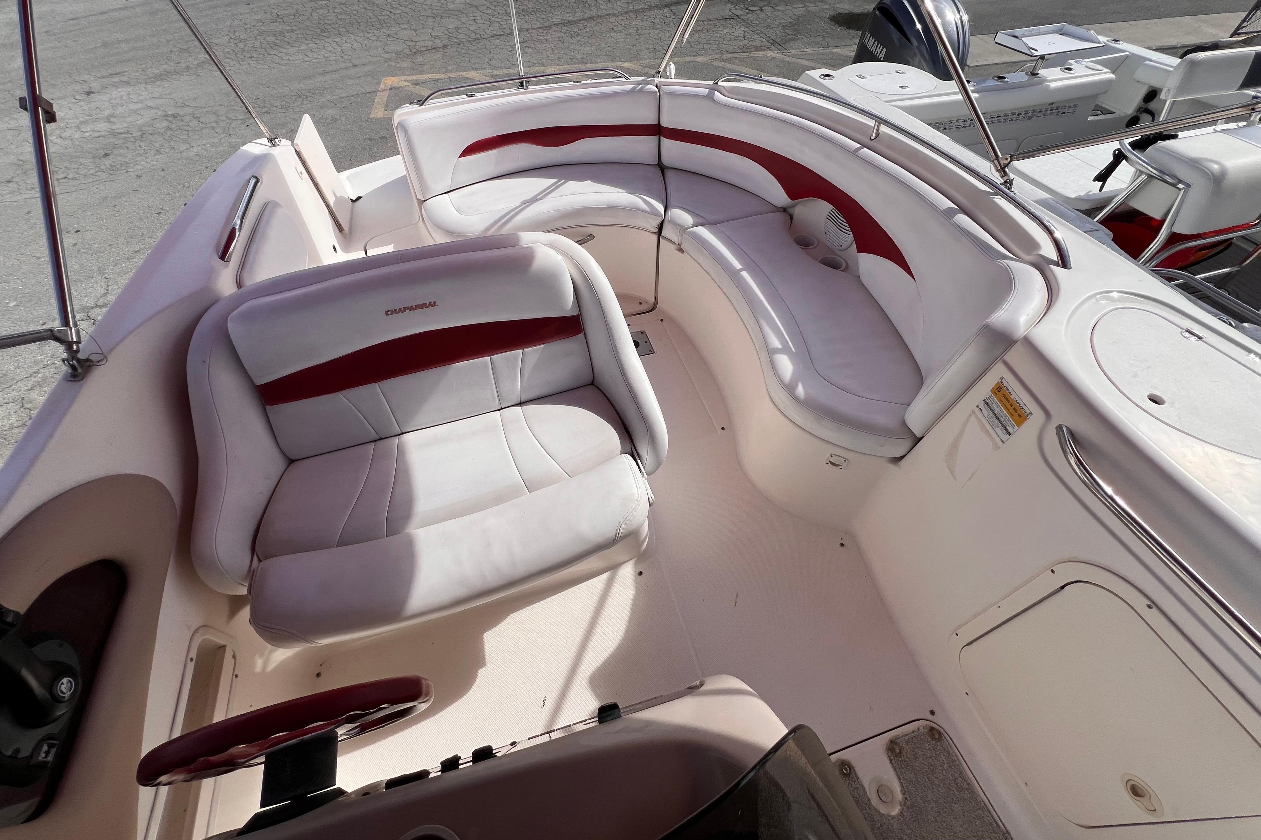 2002 Chaparral 232 Sunesta boat interior with white and red seating.
