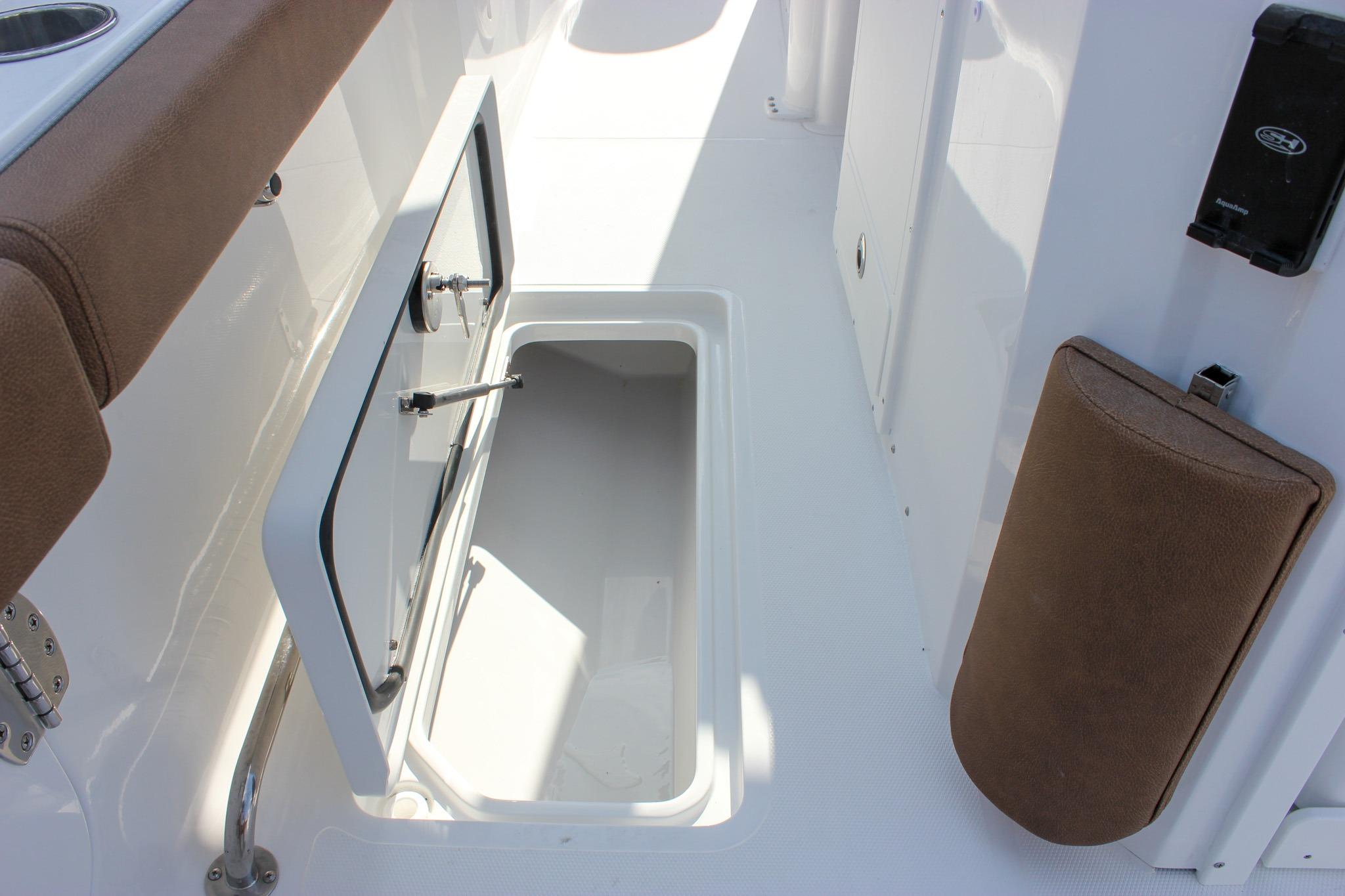 2027 Sea Hunt Ultra 275 SE boat storage compartment with open hatch and cushioned seating.
