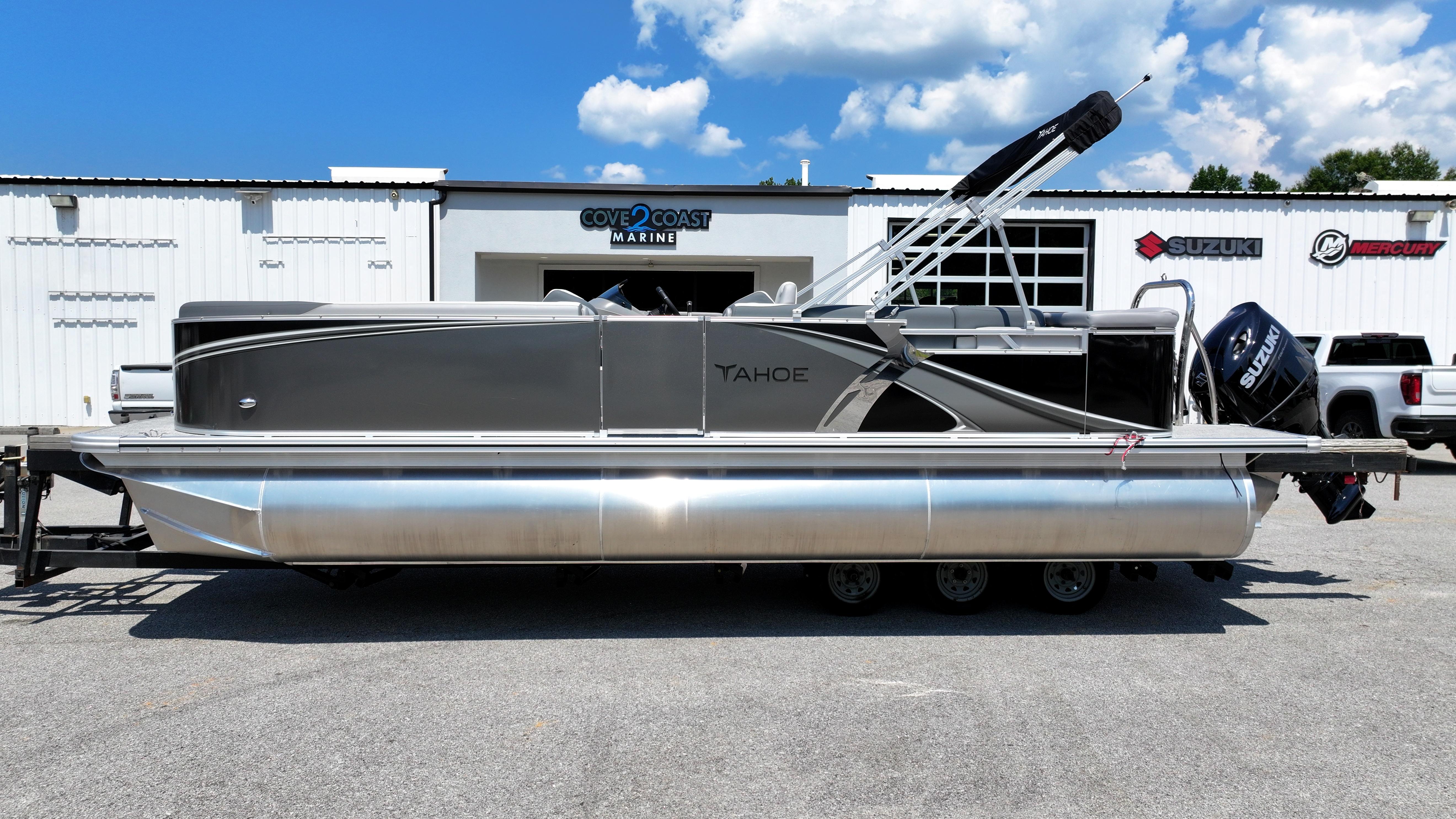 2025 Tahoe Pontoon LTZ Cruise boat parked at Cove 2 Coast Marine dealership.