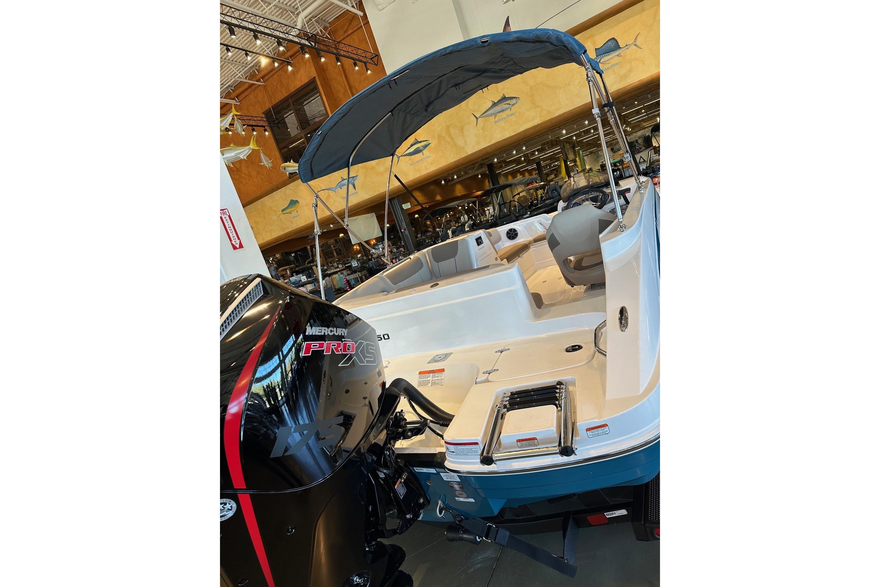 2026 Tahoe 1950 boat with Mercury Pro XS engine displayed indoors.