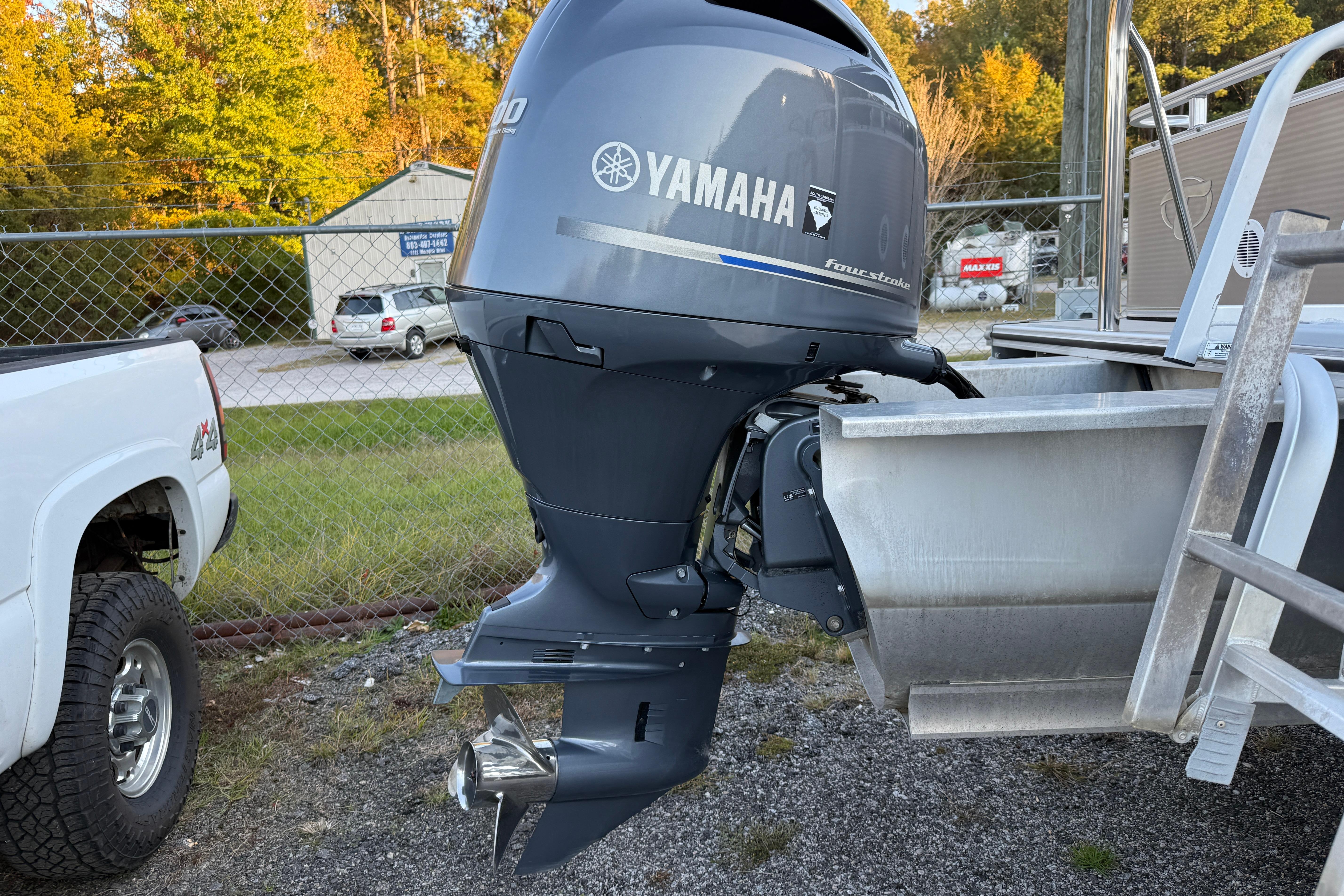 2011 Tahoe Pontoon 2485 DRL with Yamaha outboard motor in a parking area.