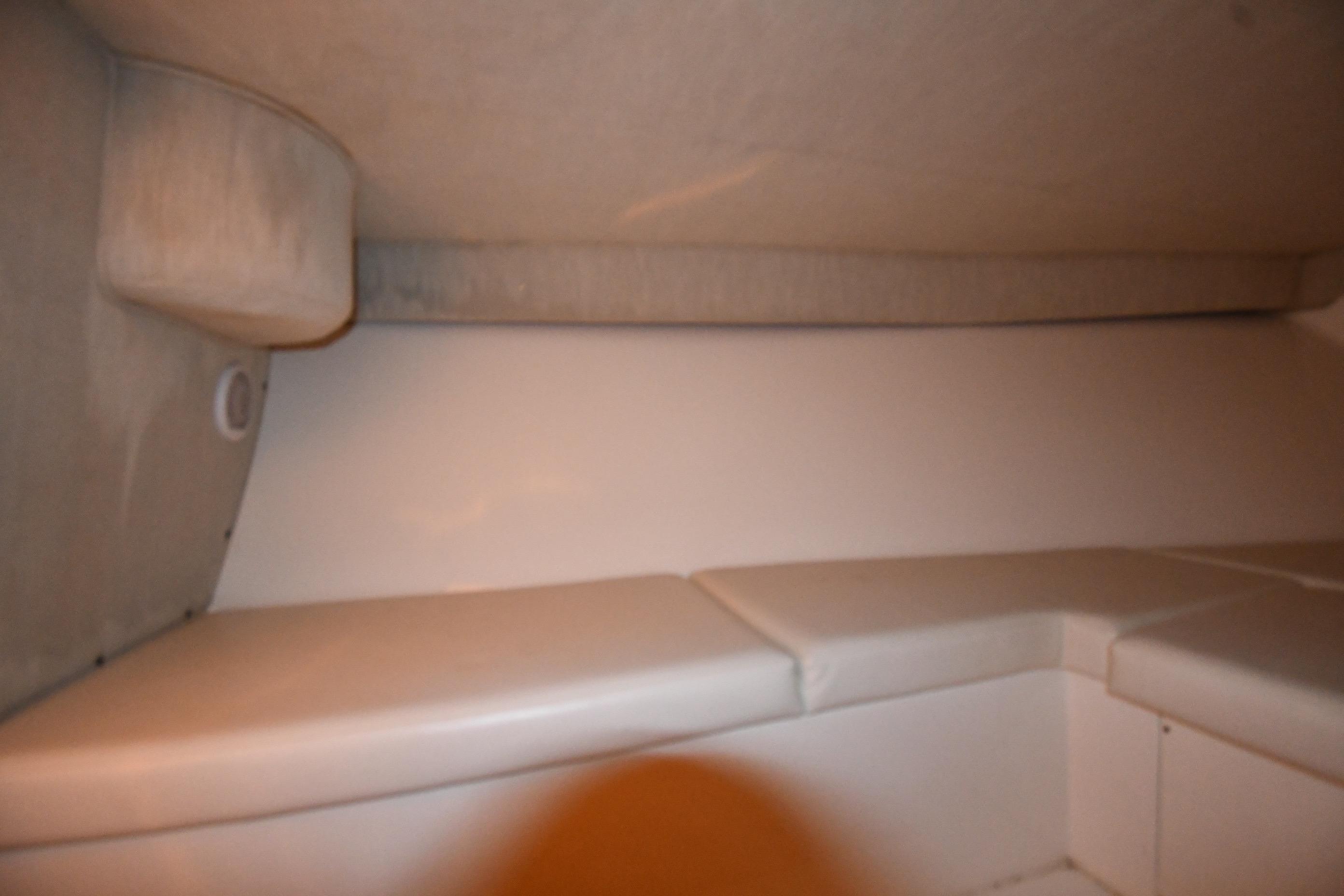 Interior cabin of a 2001 Fountain 38 Center Console boat, featuring cushioned seating.