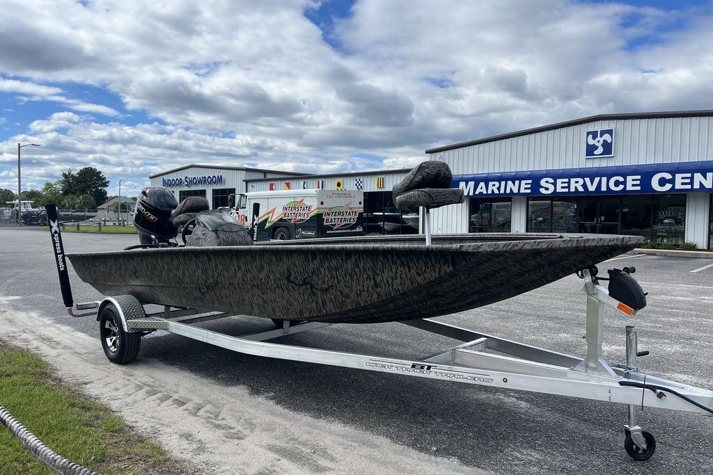 2026 Xpress XP200 boat on trailer outside marine service center.