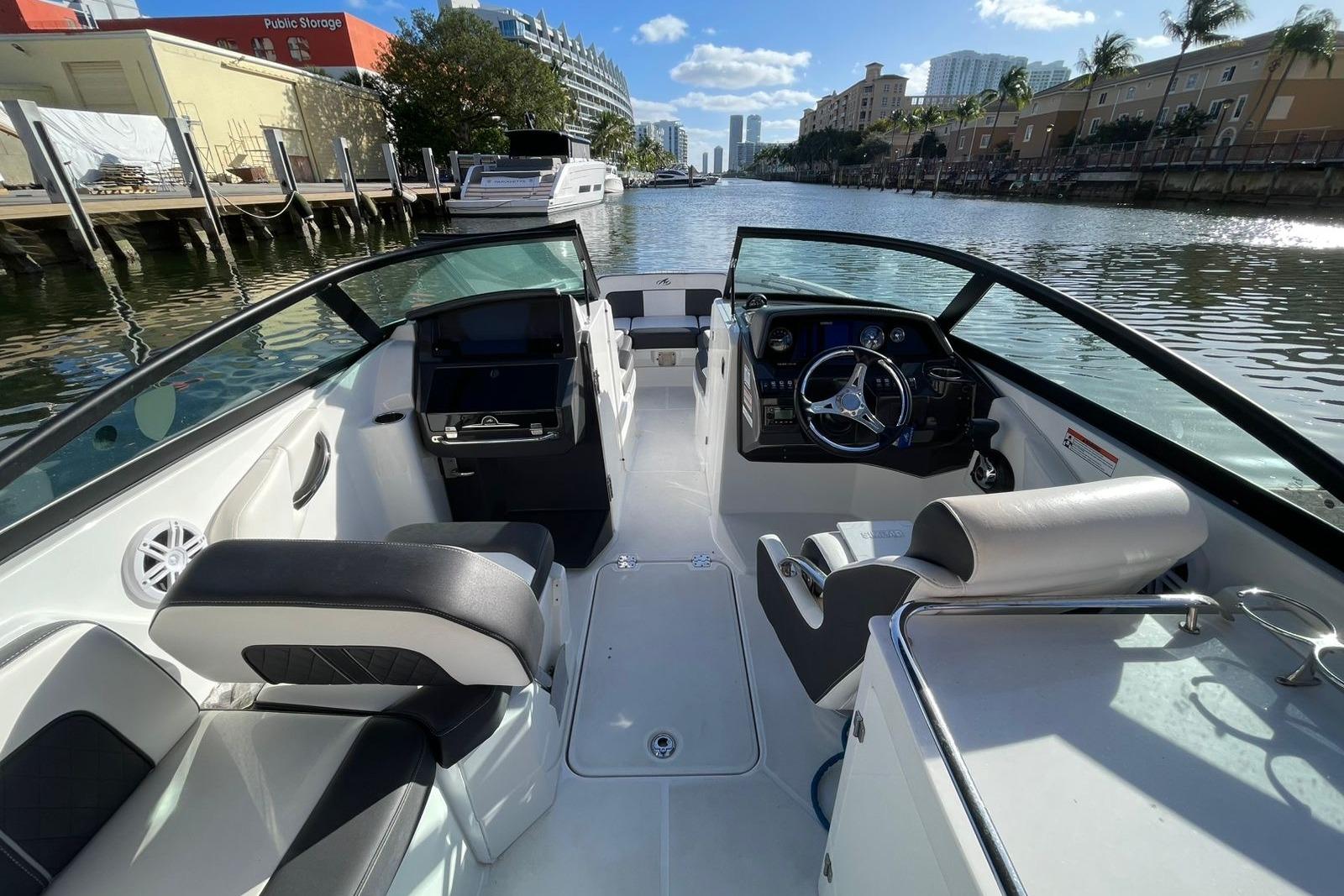 Interior view of a 2022 Monterey M-65 boat, featuring sleek seating and modern controls.