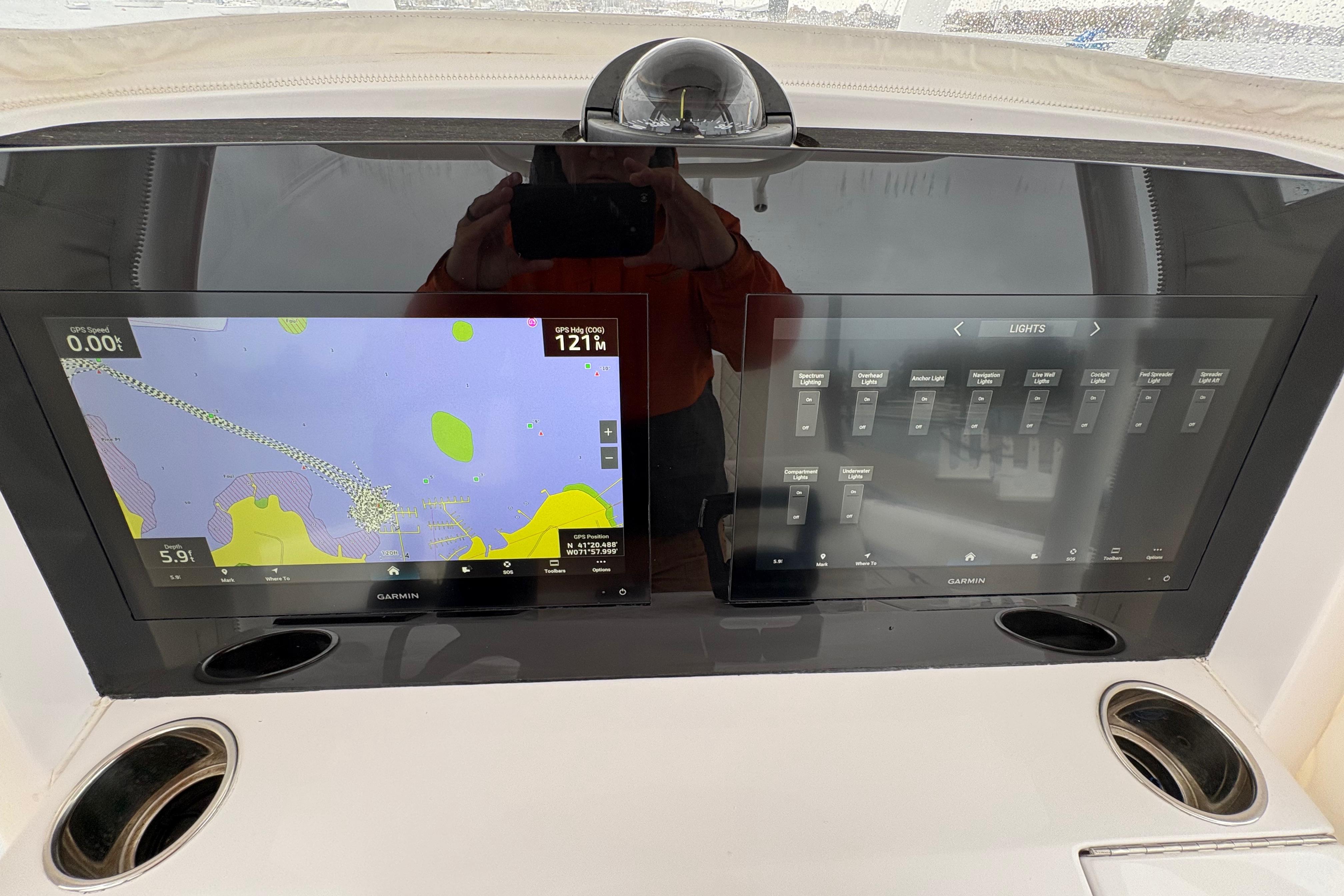 2023 Jupiter 30 boat dashboard with dual Garmin displays showing navigation and control settings.