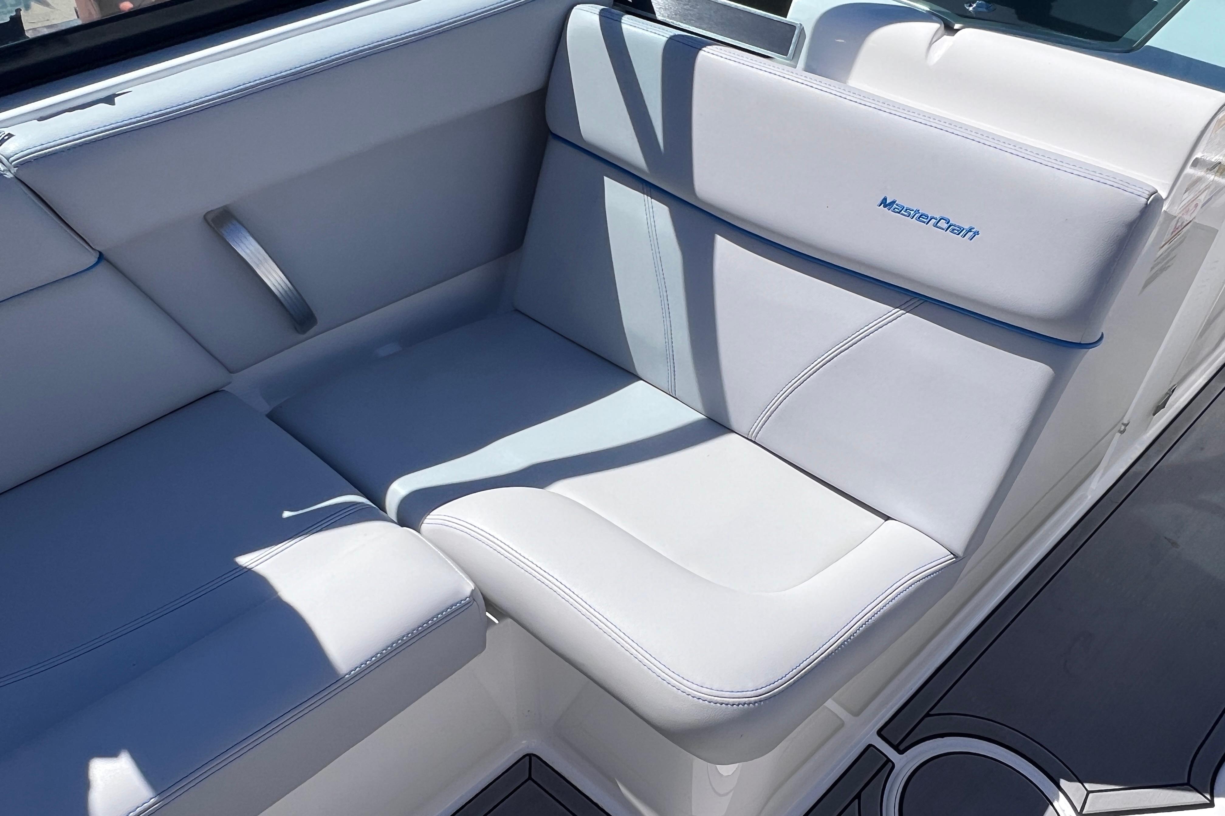 2021 MasterCraft XT23 boat interior with white cushioned seating.