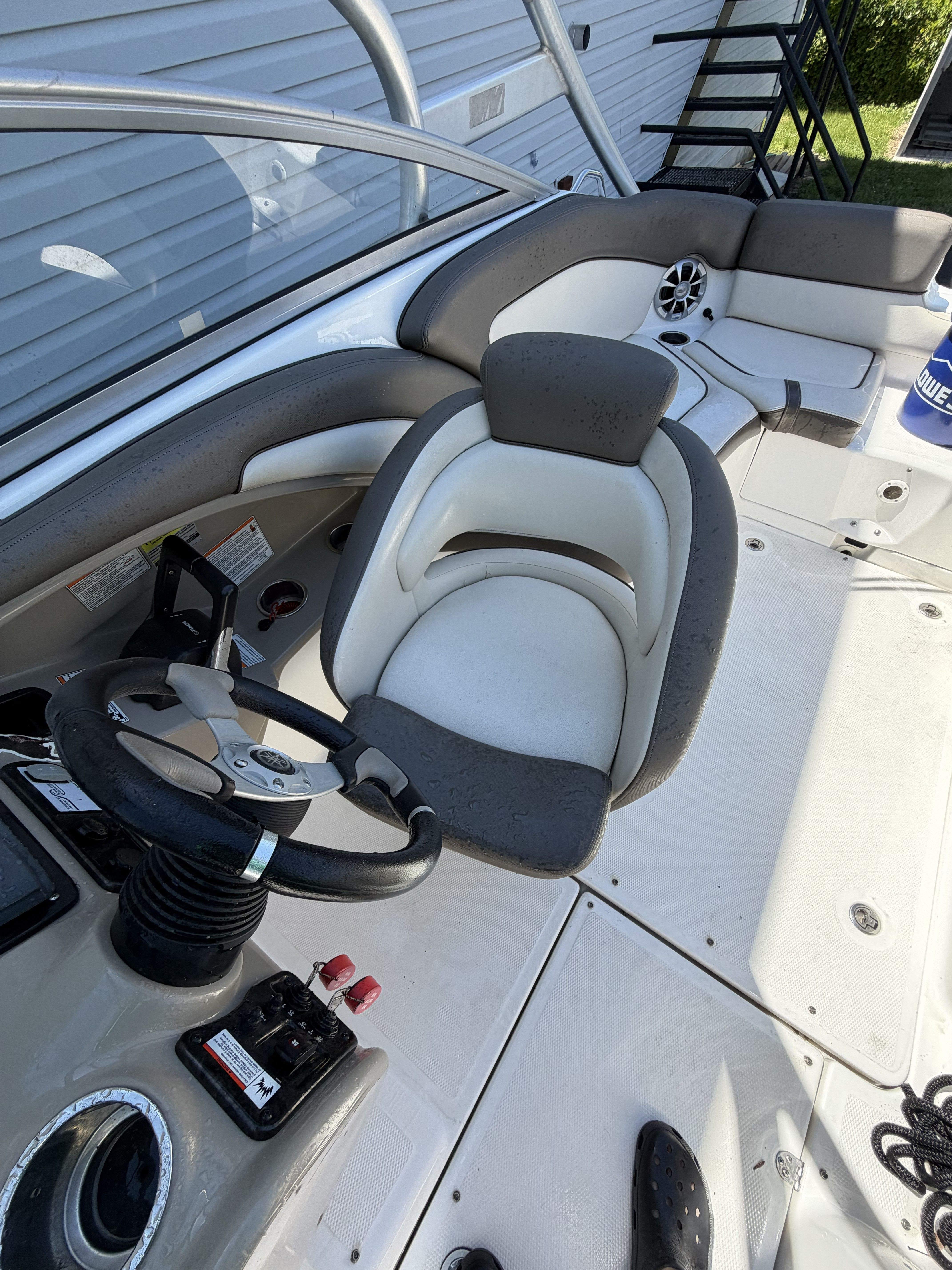 Interior of a 2012 Yamaha Boats 242 with helm and seating.