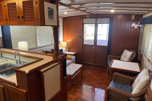 Interior of a 1986 Kadey-Krogen 42 yacht with cozy seating and wooden finishes.