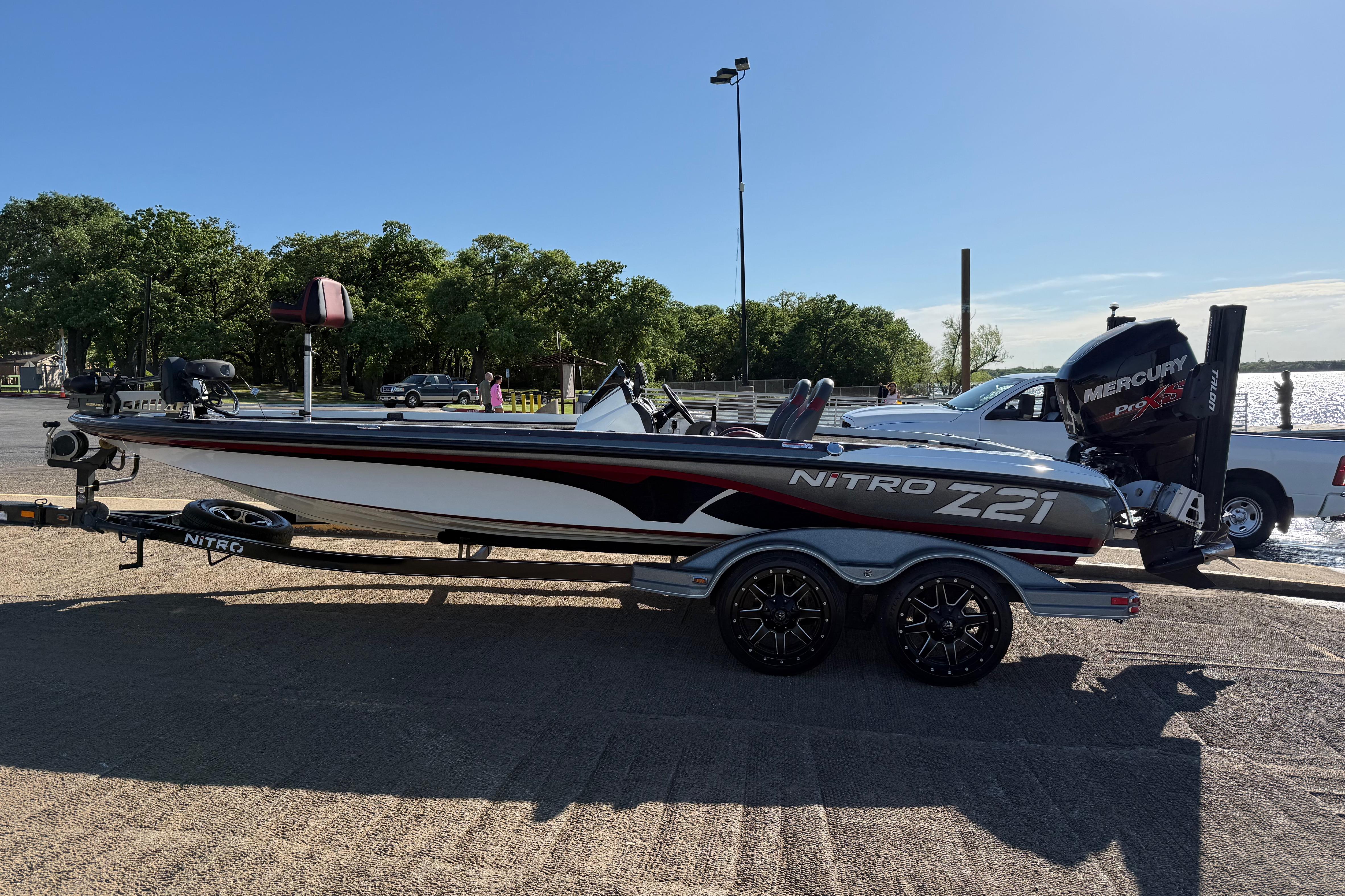 2016 Nitro Z21 boat on trailer by lakeside, featuring Mercury Pro XS engine.