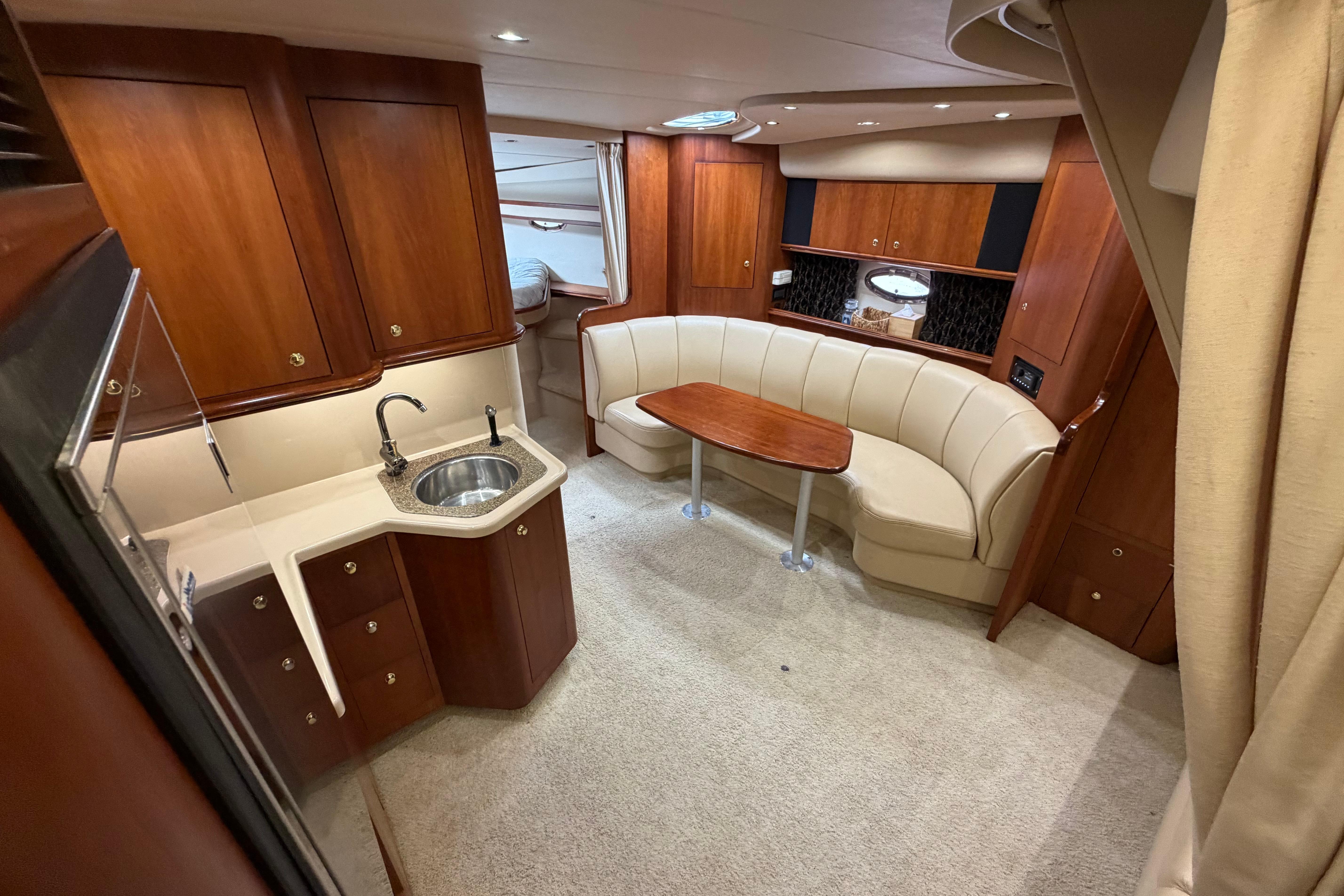 Luxurious interior of 2001 Cruisers Yachts 3672 Express with elegant wood cabinetry and seating.