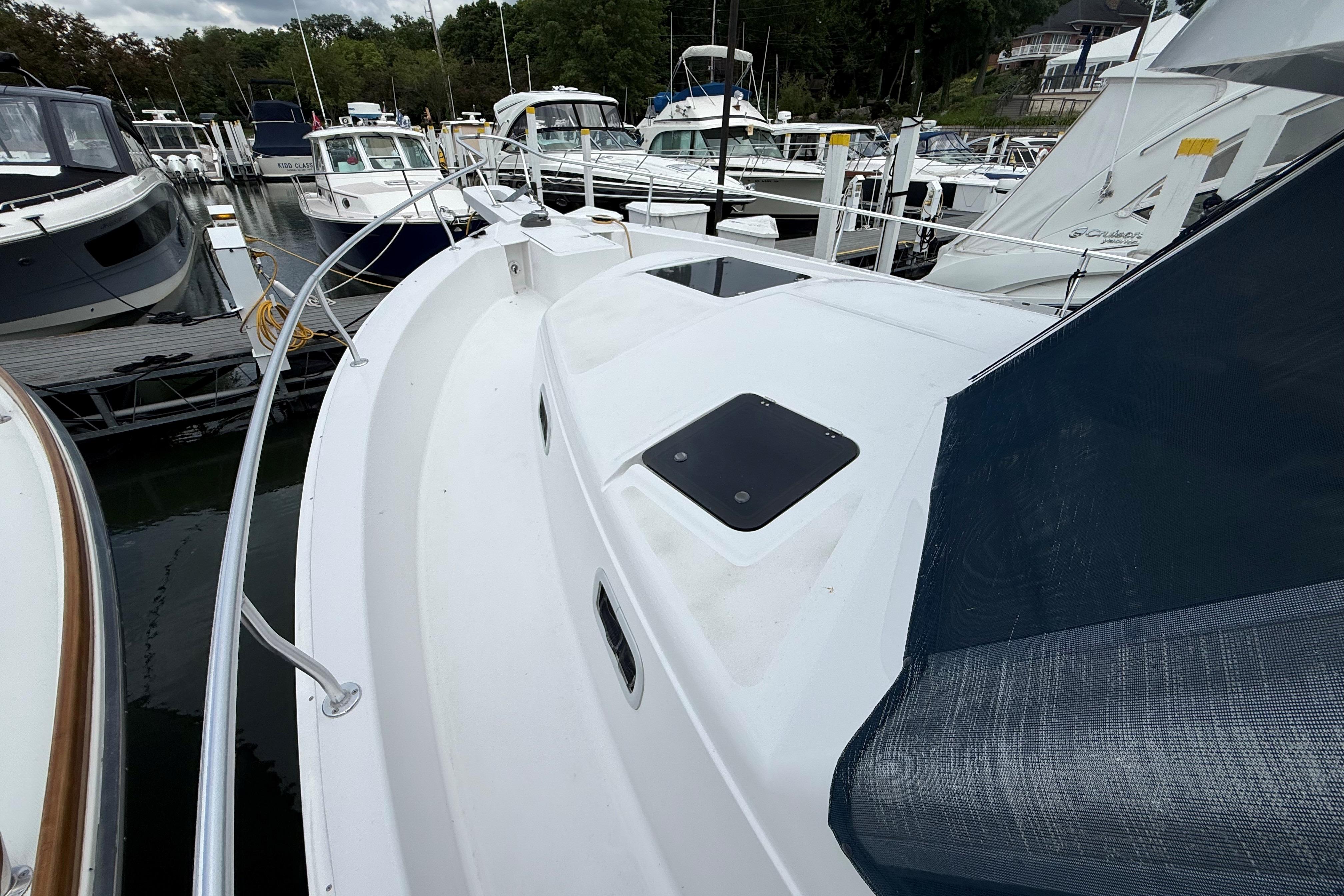 1999 Mainship 350 Trawler docked at marina, surrounded by other boats.