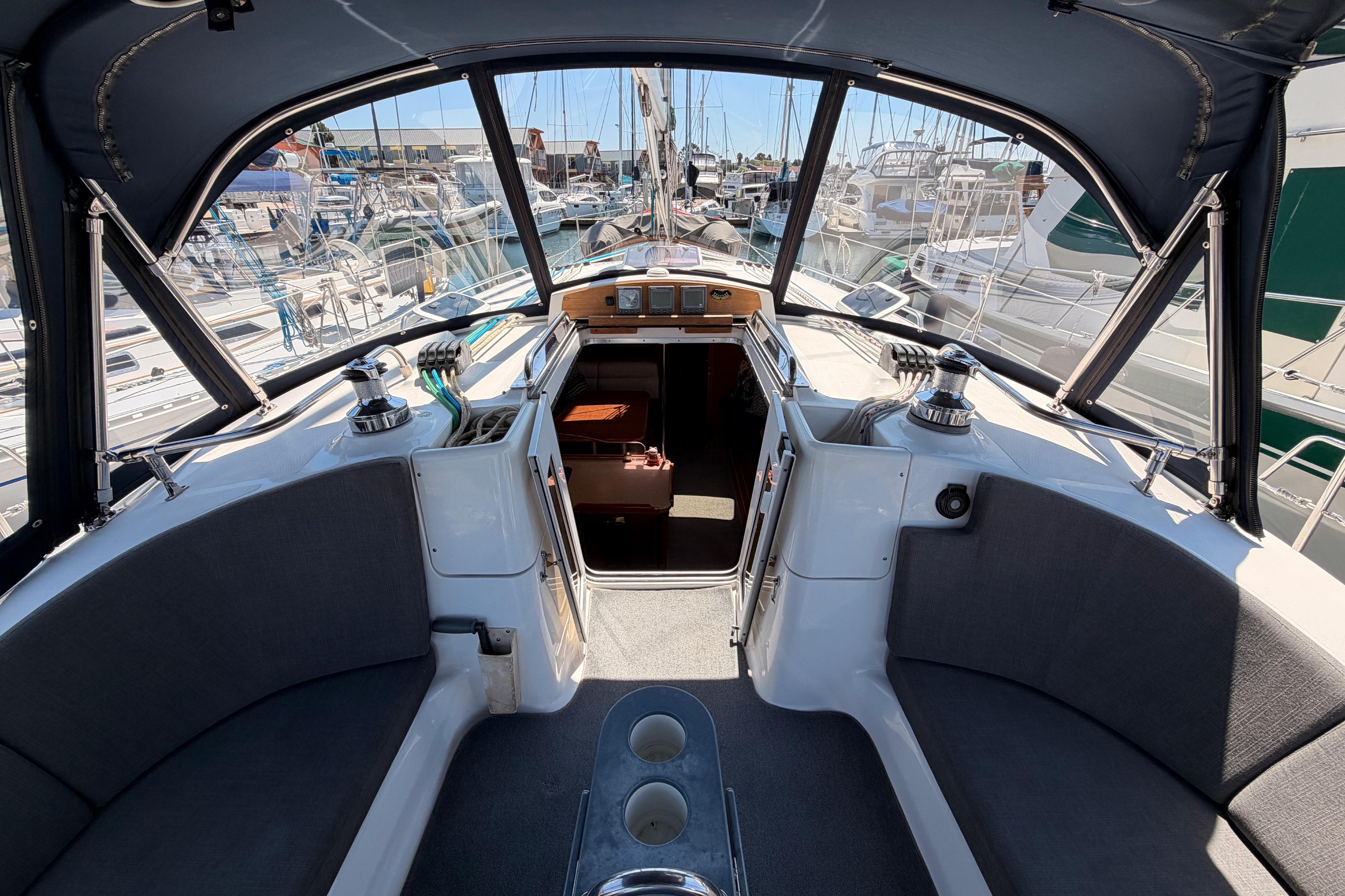 2008 Hunter 45 Deck Salon cockpit with marina view, featuring seating and navigation equipment.