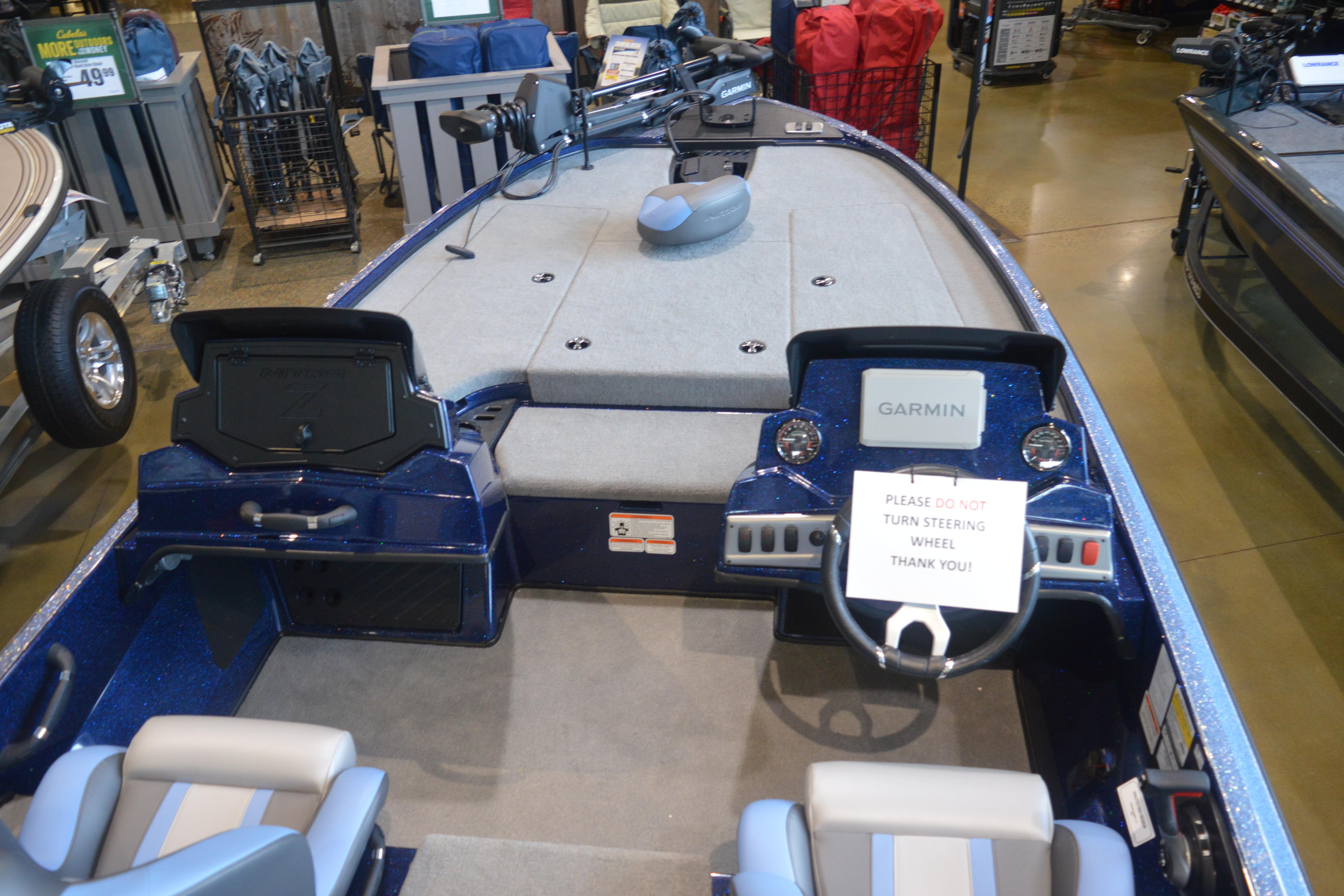 2026 Nitro Z18 Pro boat interior with Garmin navigation system and steering wheel warning sign.