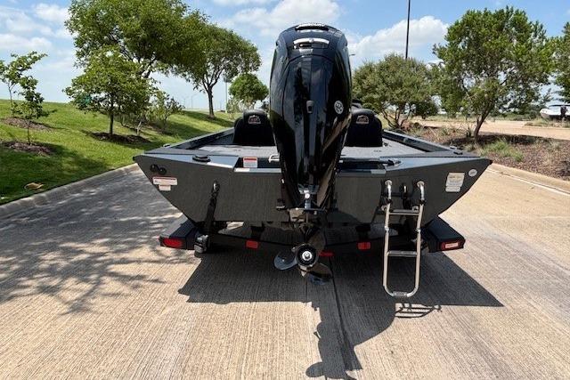 2026 Ranger RT188 boat on trailer, parked on sunny road with trees in background.