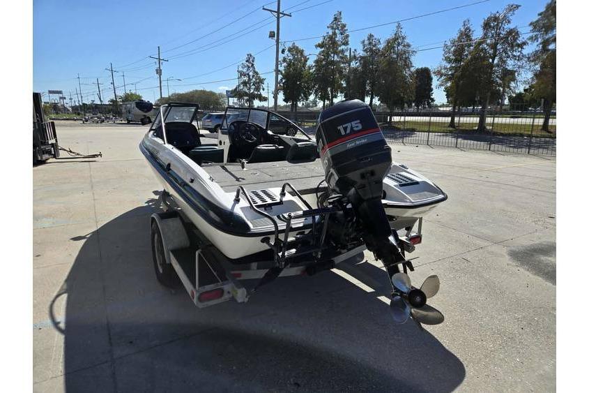 1997 Javelin 389 FS boat with 175 horsepower motor on trailer, parked outdoors.