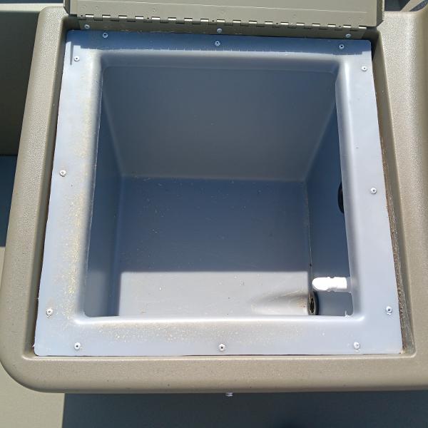 2025 Tracker Grizzly 1754 SC boat storage compartment, open and empty.