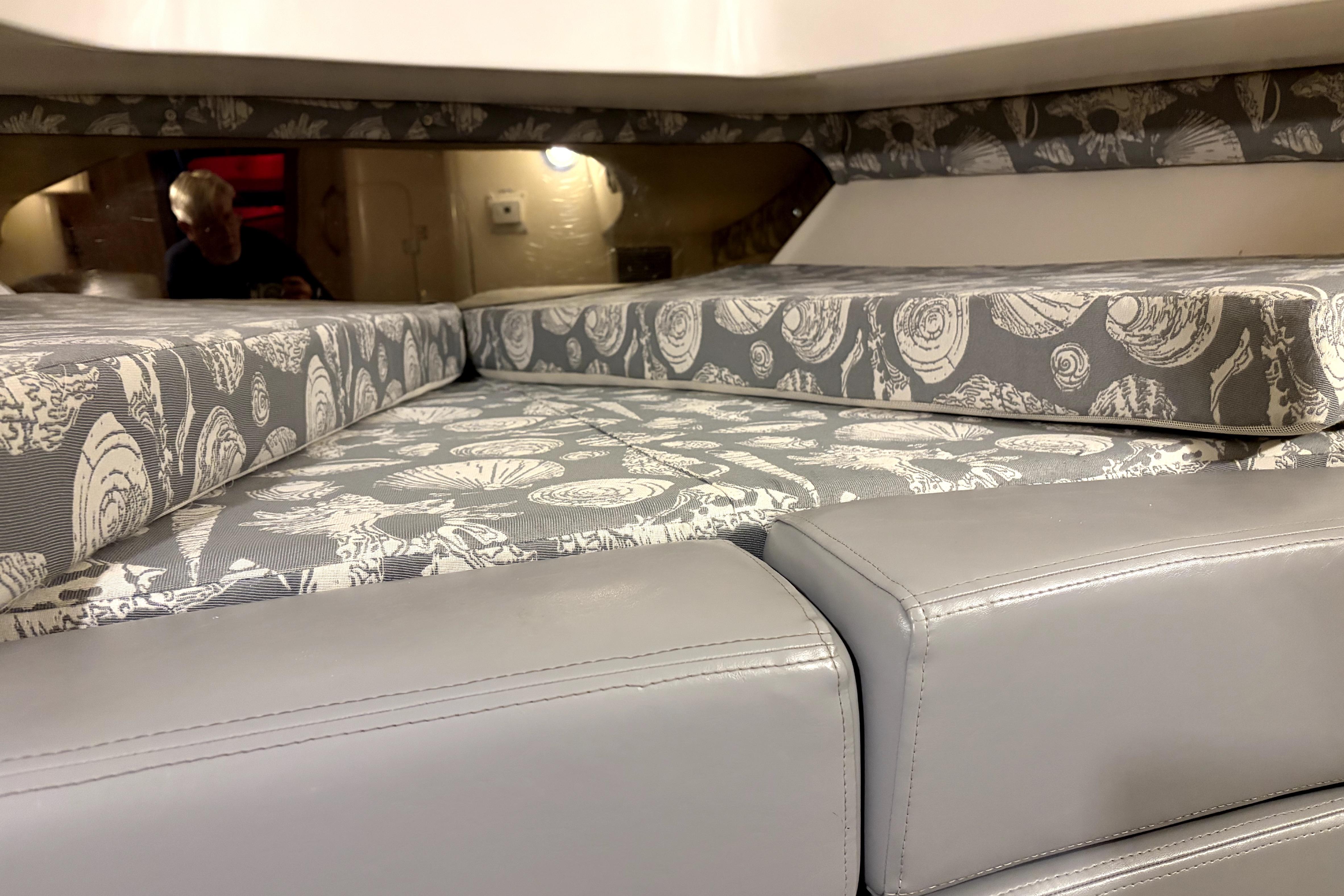Interior cabin of a 1998 Intrepid 339 Walkaround with patterned cushions and sleek design.