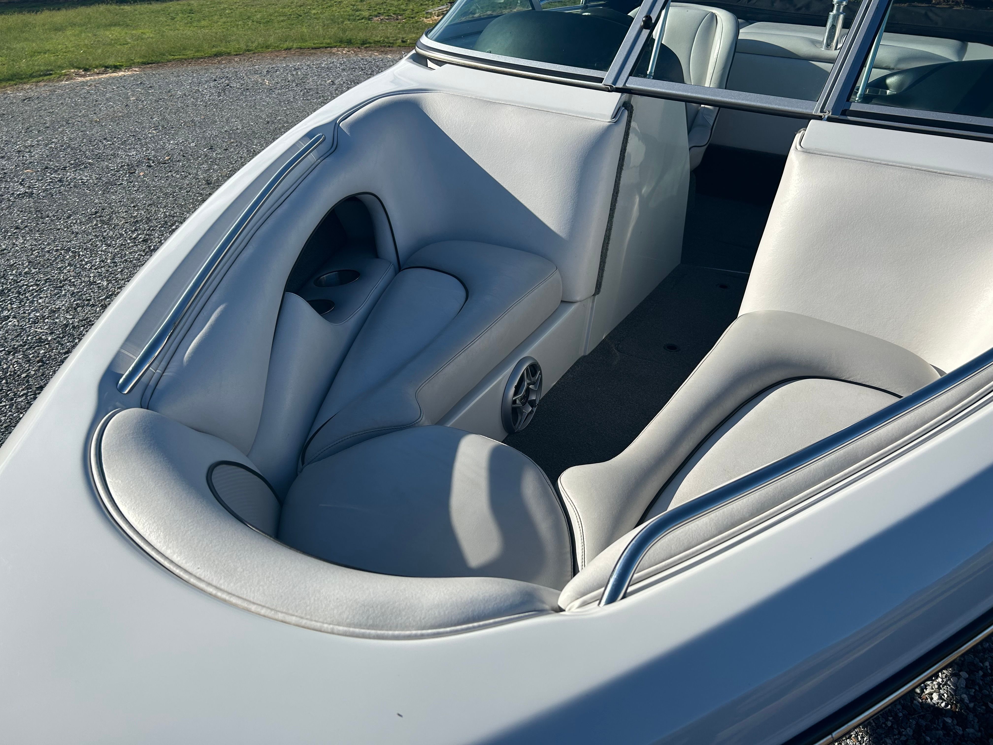 The image shows the interior of a Sanger boat with gray leather seats.