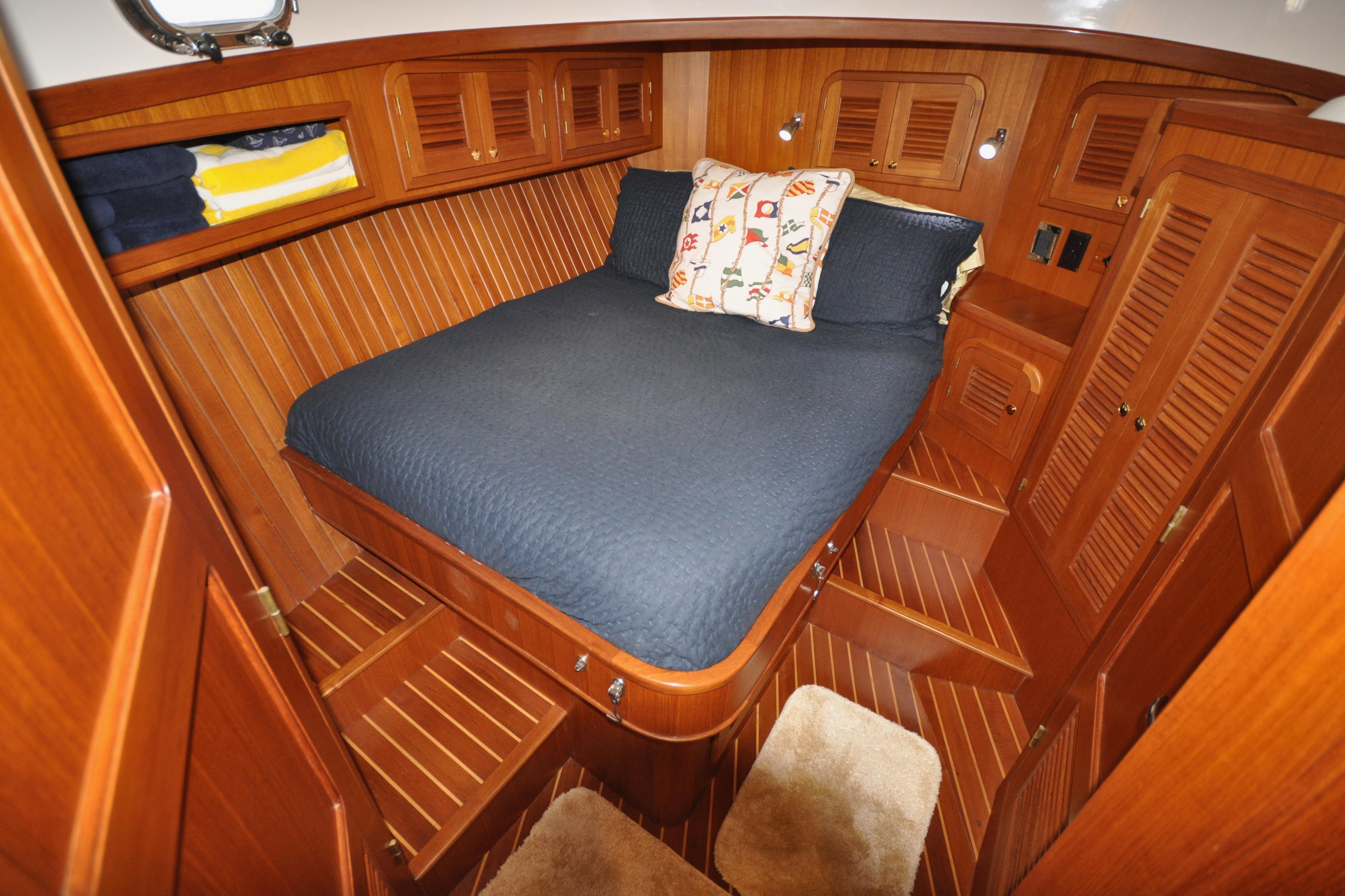 2015 Helmsman Trawlers 31 Sedan cabin with wooden interior and cozy bed.