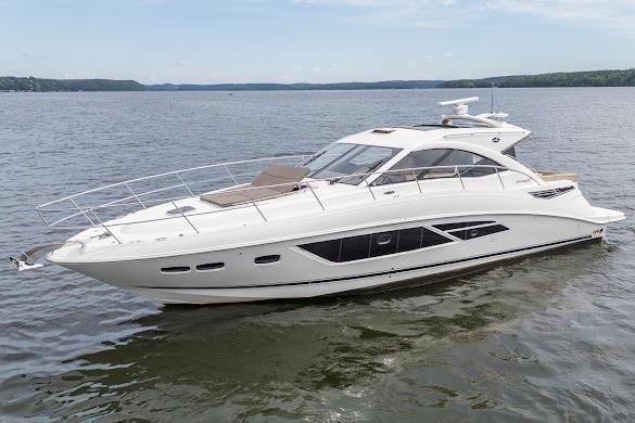 2016 Sea Ray Sundancer 510 yacht cruising on a calm lake under a clear sky.