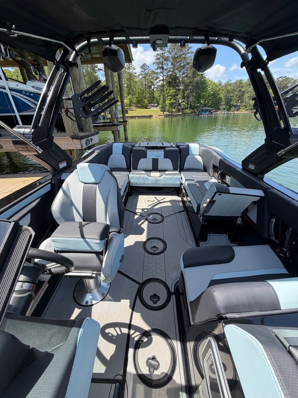 Interior of a 2023 MasterCraft X24 boat on a lake.