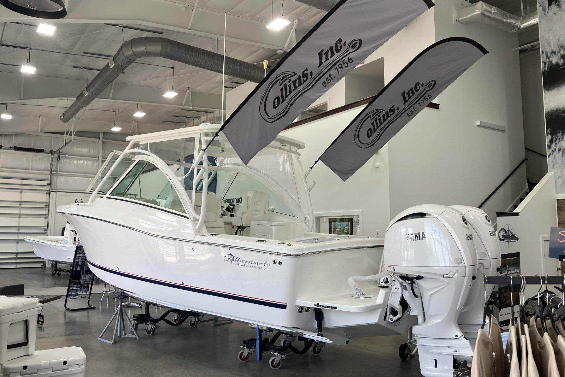 2026 Albemarle 27 Dual Console boat displayed indoors at Collins Inc. showroom.
