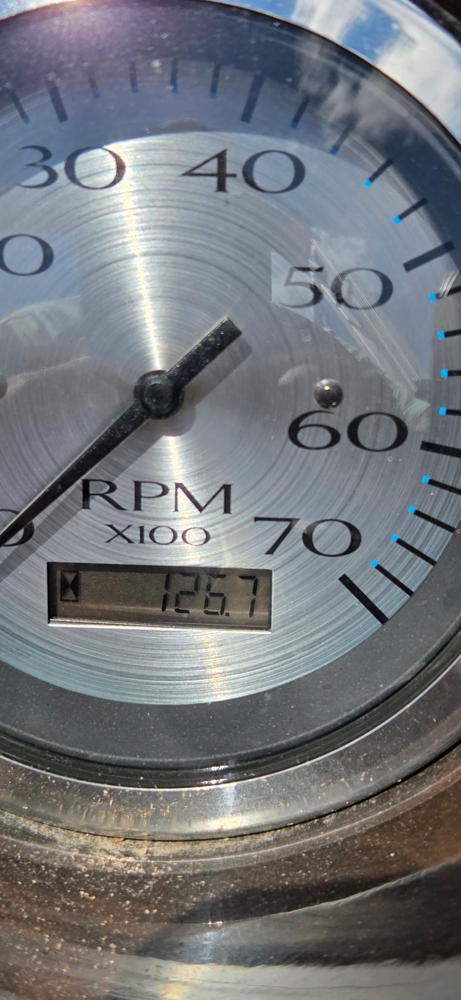 Close-up of a tachometer showing 1267 RPM.