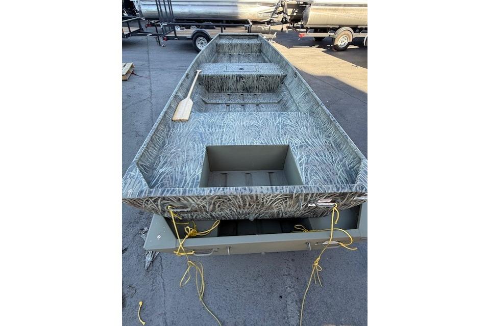 2026 Tracker Grizzly 15 Jon boat with camouflage interior, parked on a trailer.
