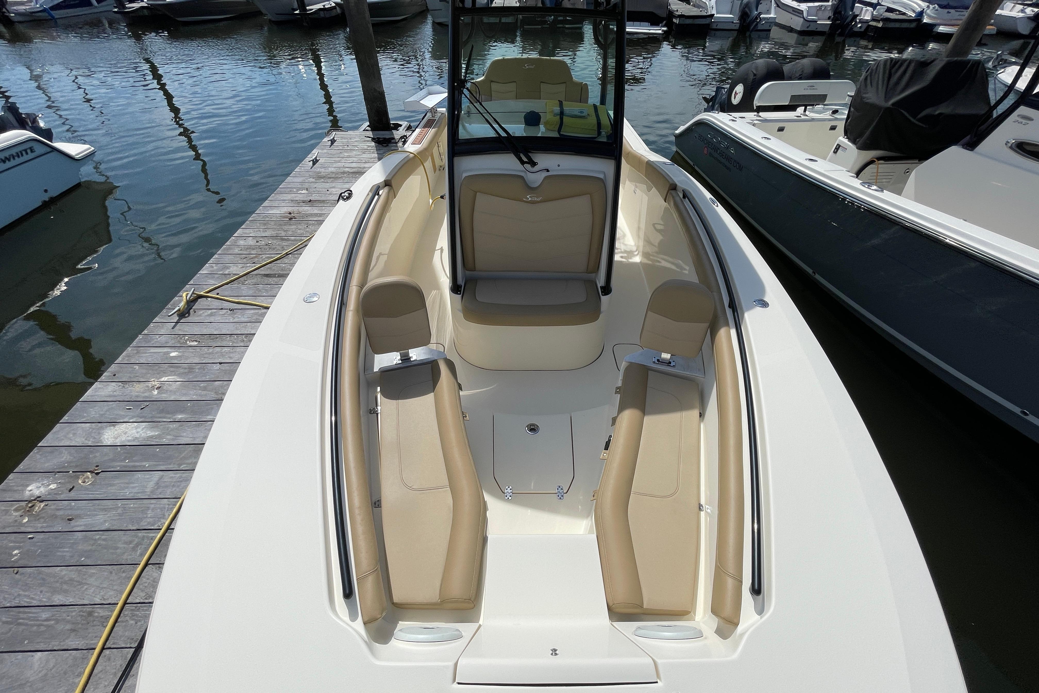 2020 Scout 255 LXF boat docked, featuring spacious seating and sleek design.
